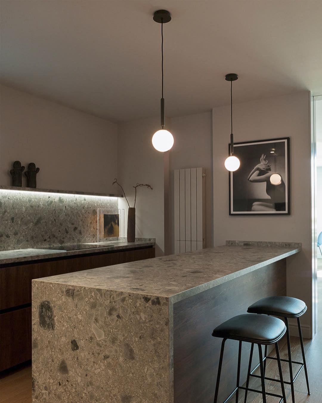 Two white globes above a stone counter