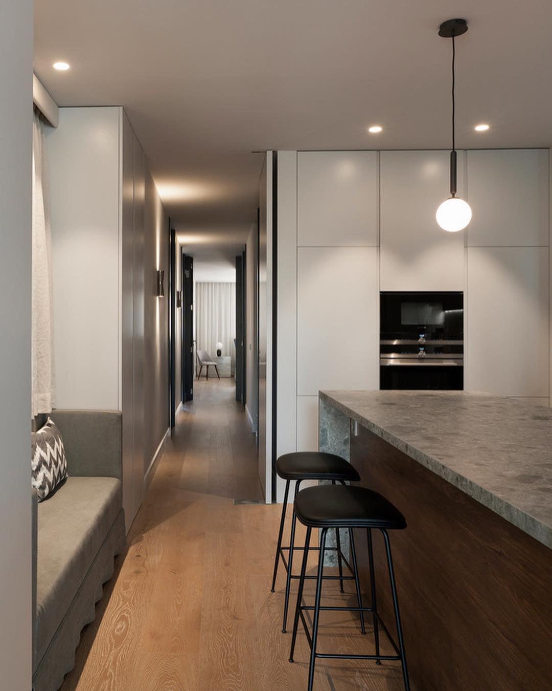 Single white globes along a kitchen island