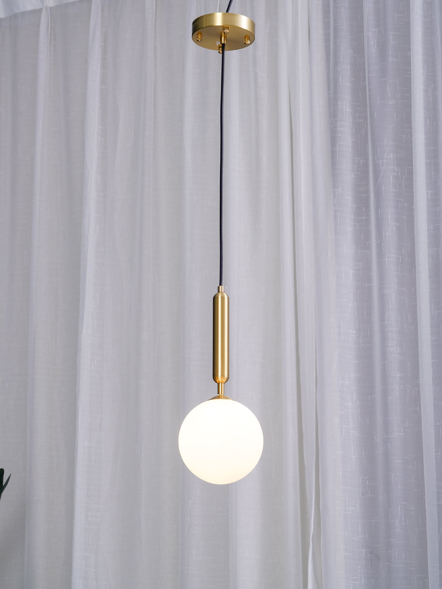 Single white globe below a gold-coloured canopy