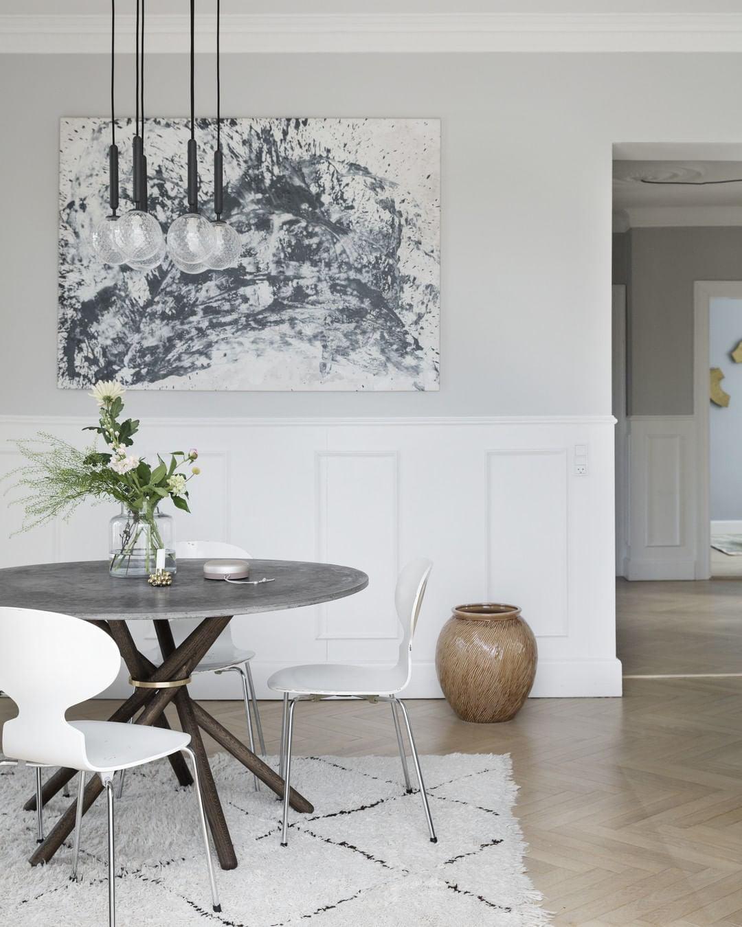 Grouped black-stem pendants above a round table