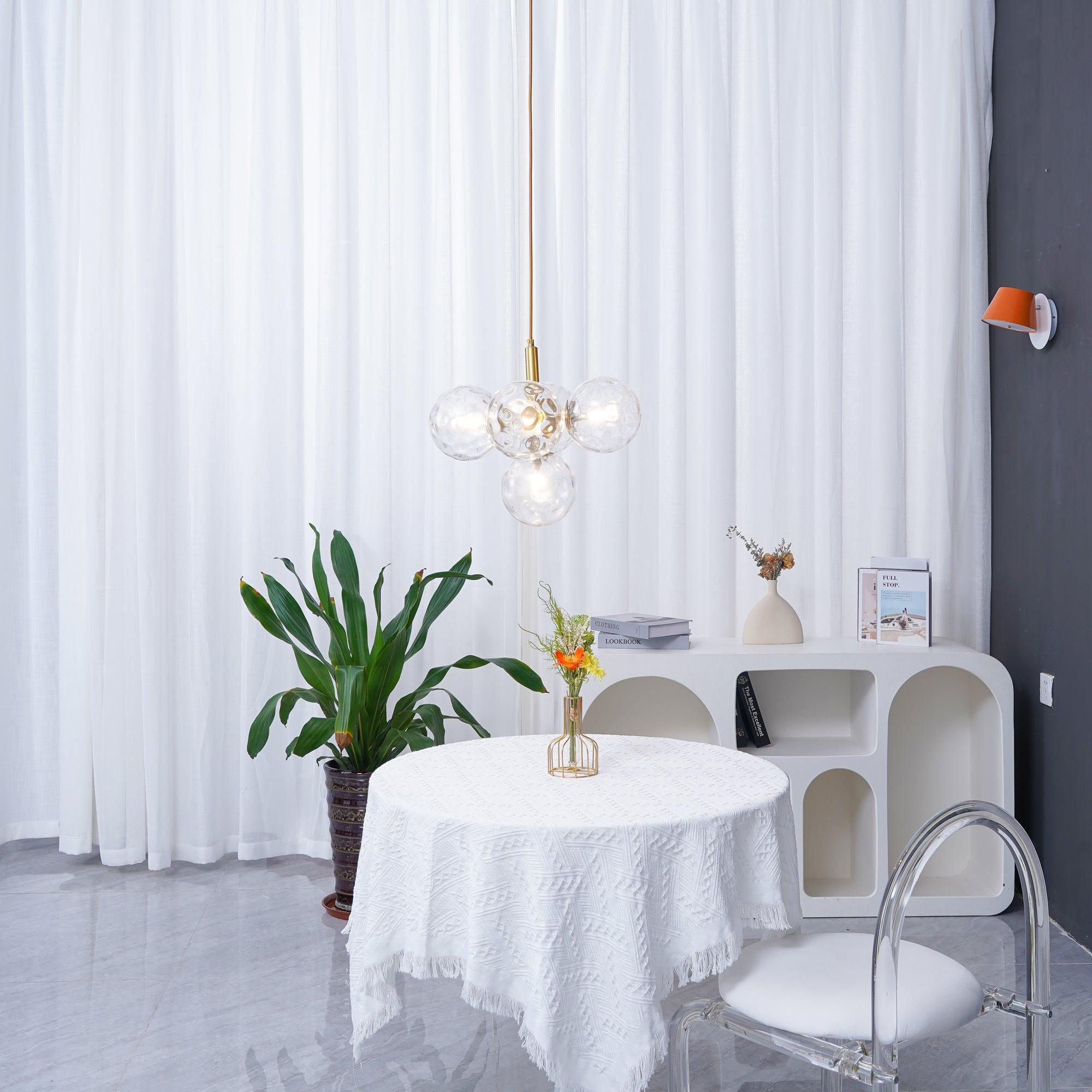 Clear glass cluster above a round table