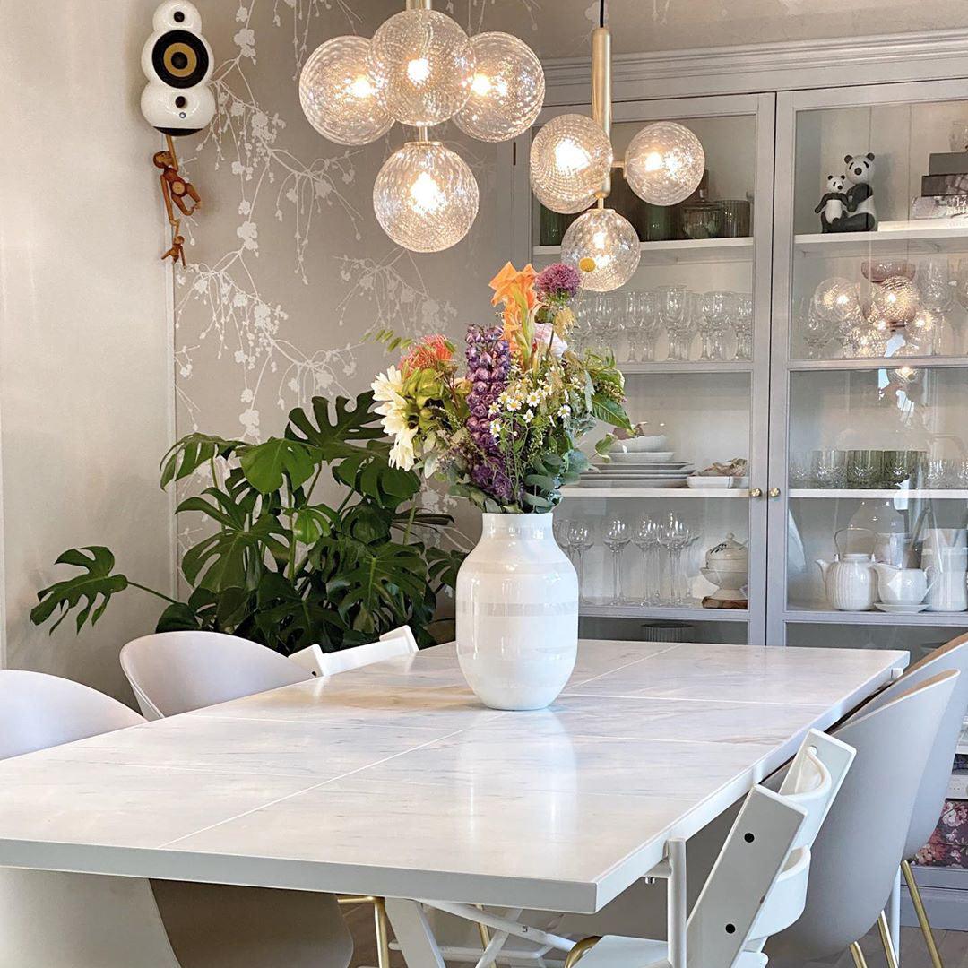 Clear globe clusters above a white dining table
