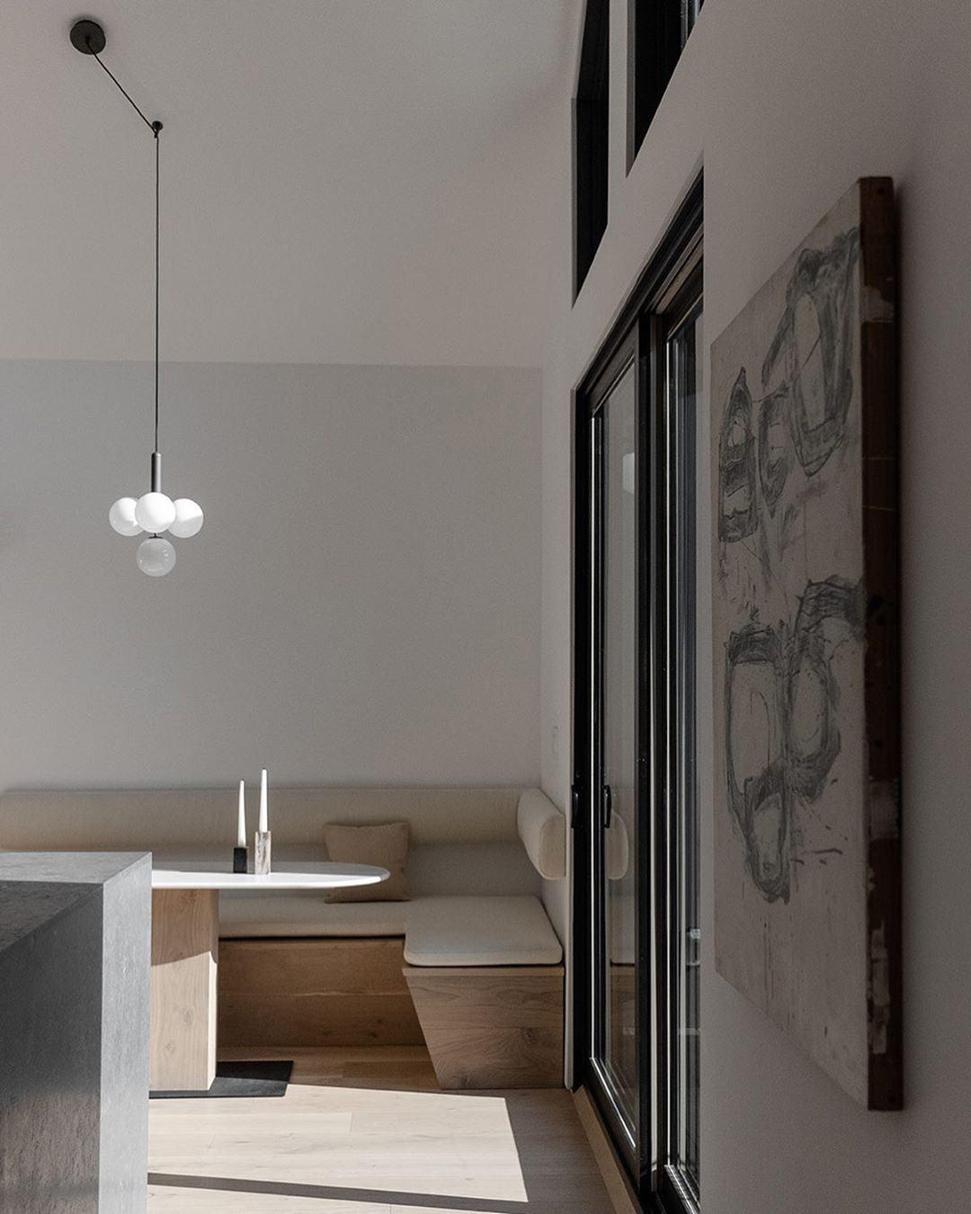 Compact glass globe cluster above a pale dining nook with upholstered bench seating