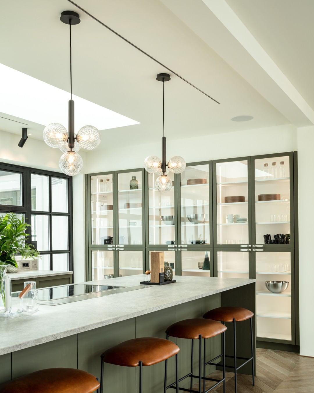 Clear glass clusters over a bright kitchen island