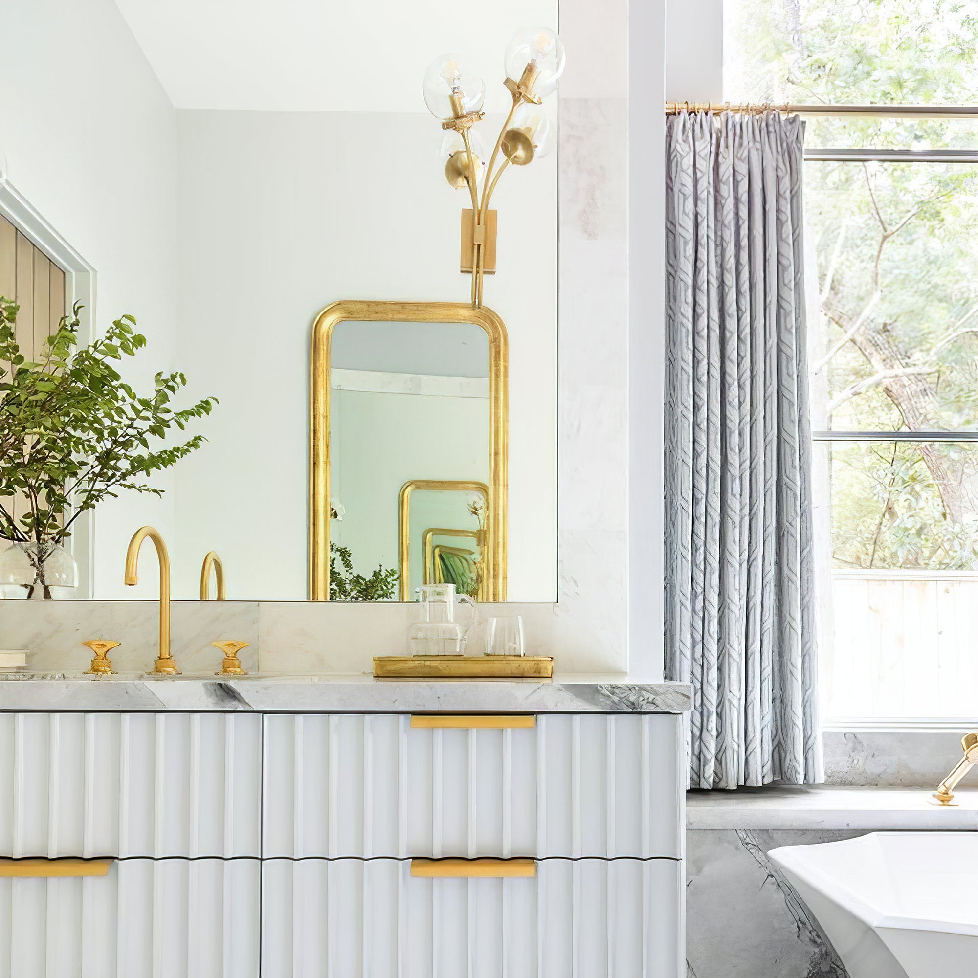 Brass clear-glass sconces near vanity mirrors