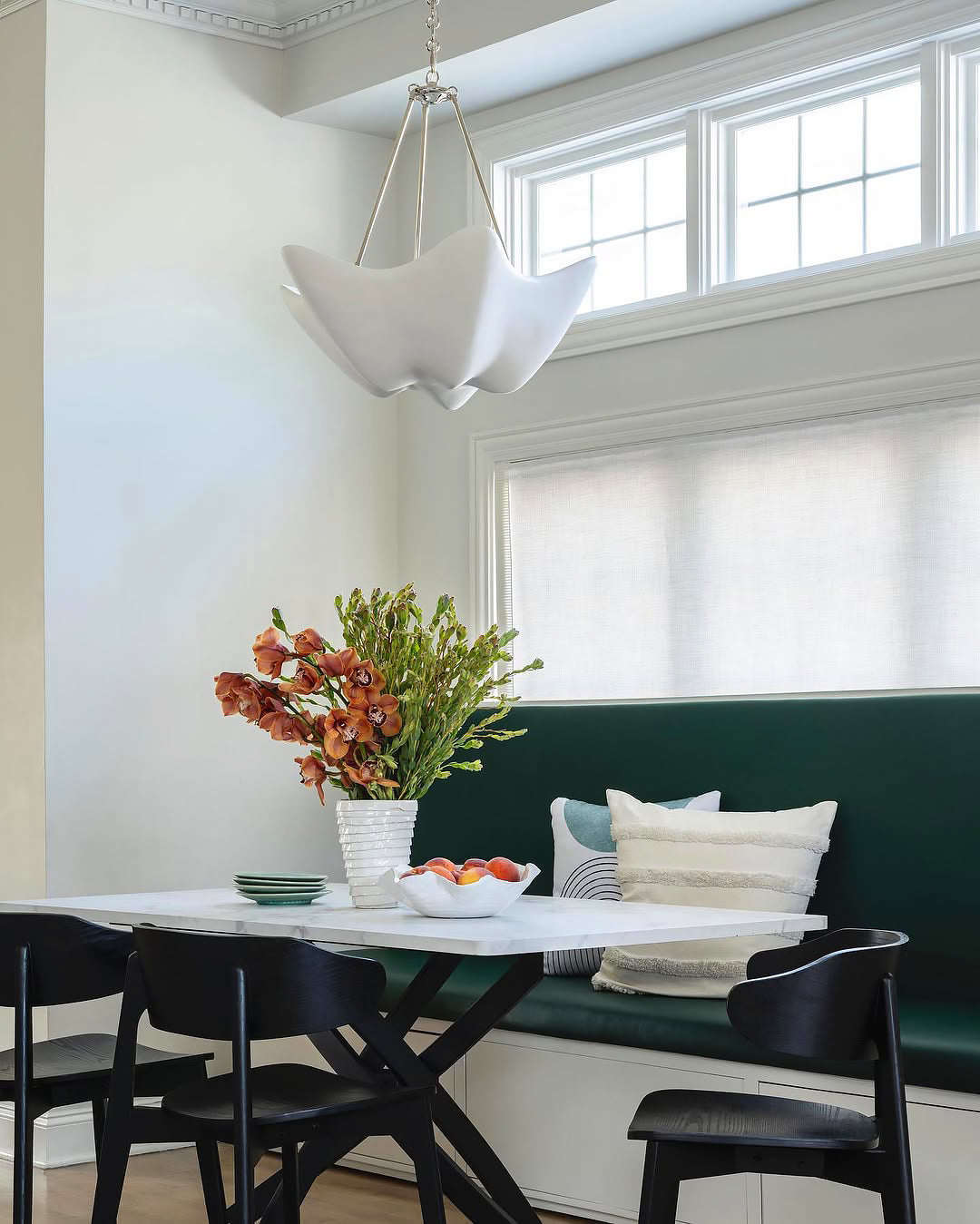 White Cosima chandelier near tall dining-room windows