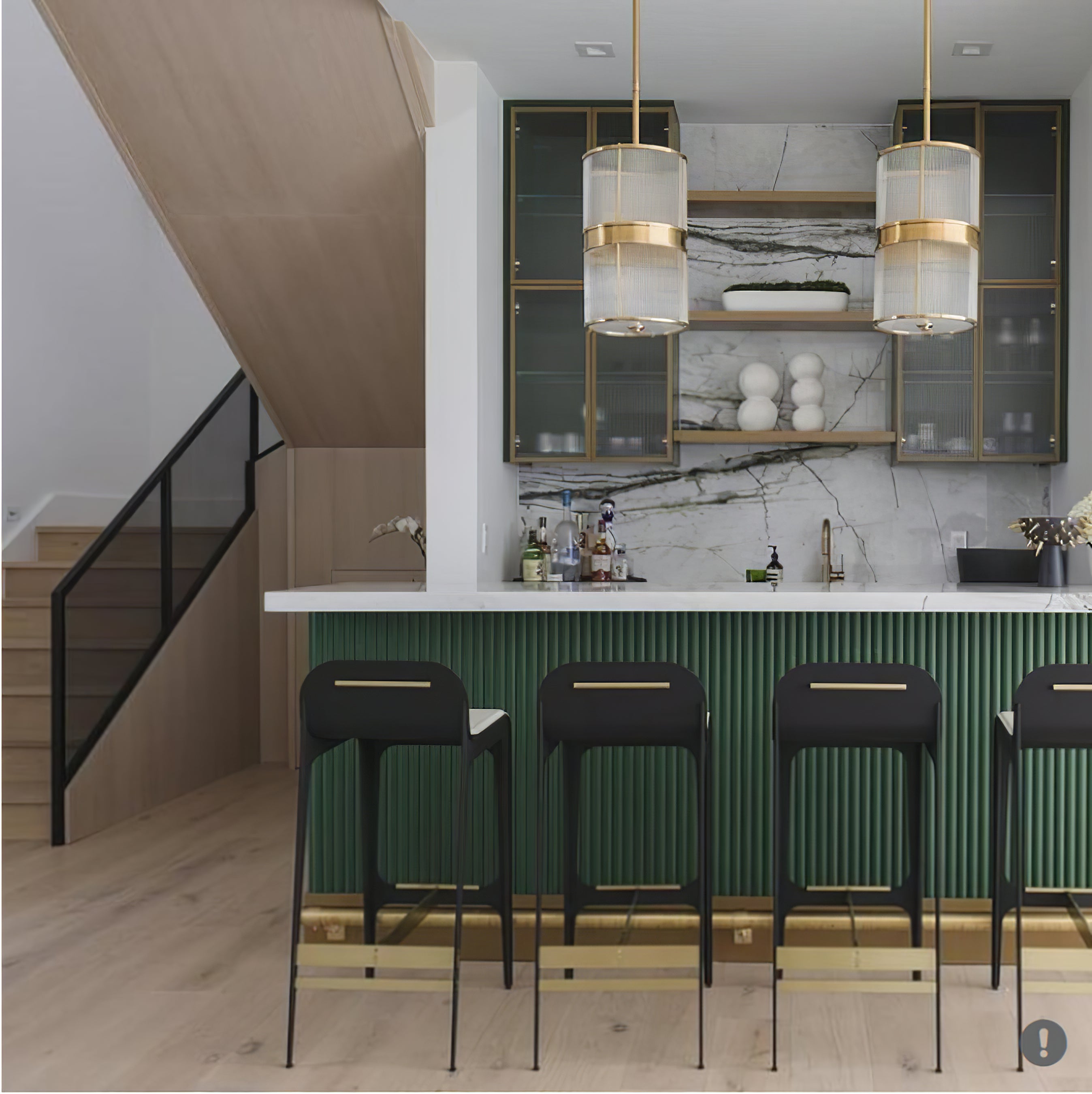 Two tall bronze-tone glass-rod drum pendants above a green ribbed kitchen island