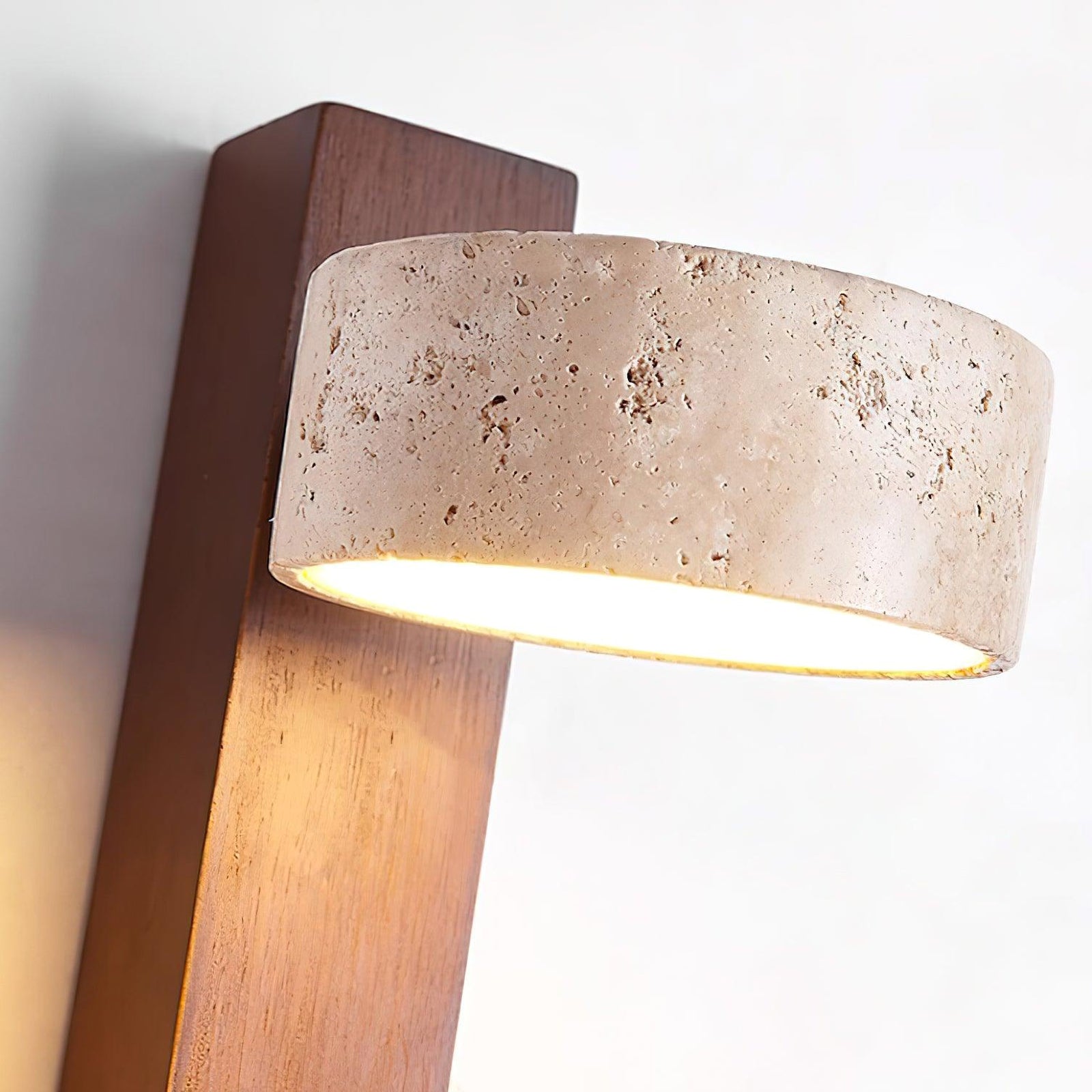 Porous travertine shade and dark wood grain close-up