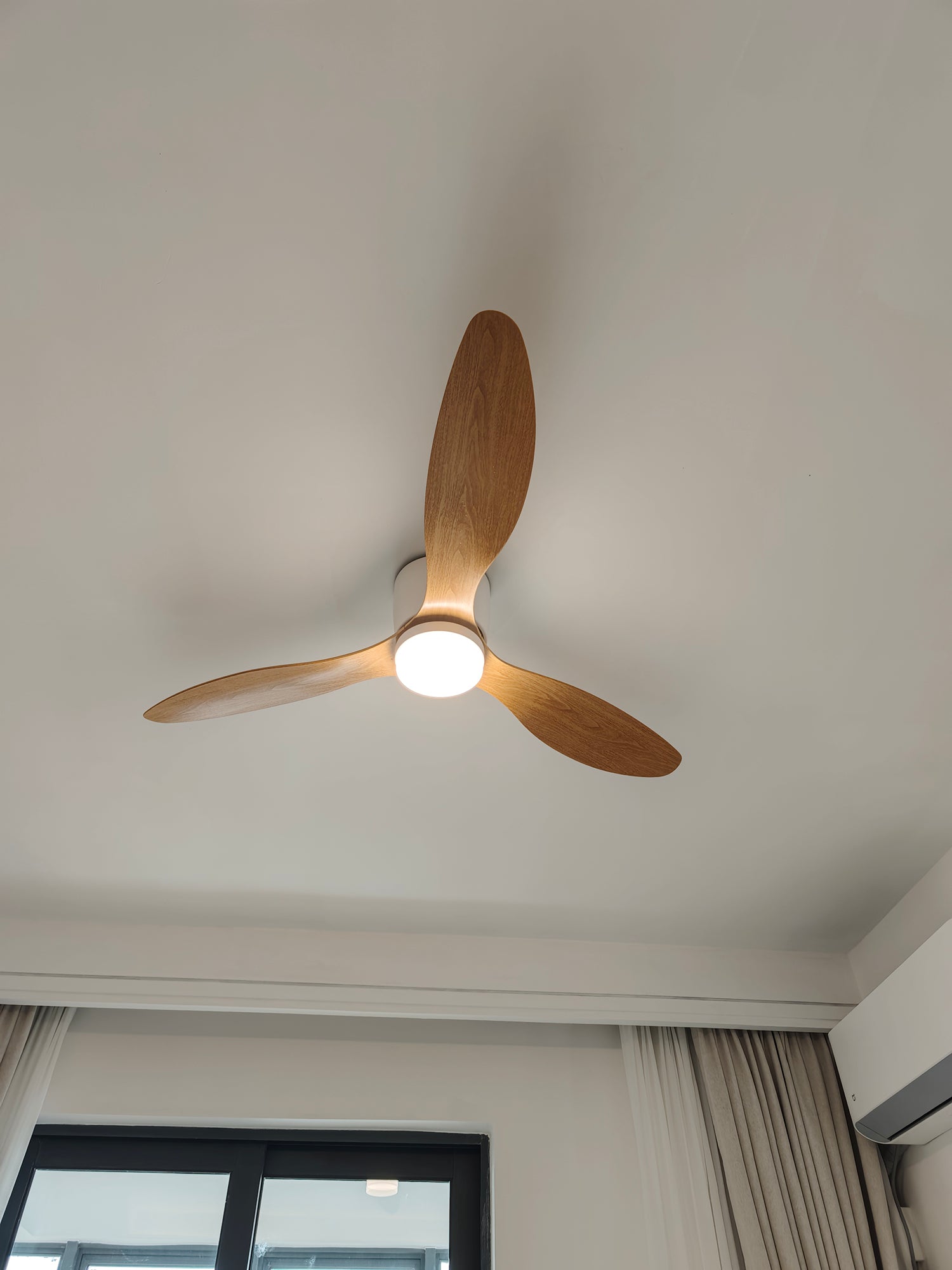 Wood-toned blades around a lit central fan panel
