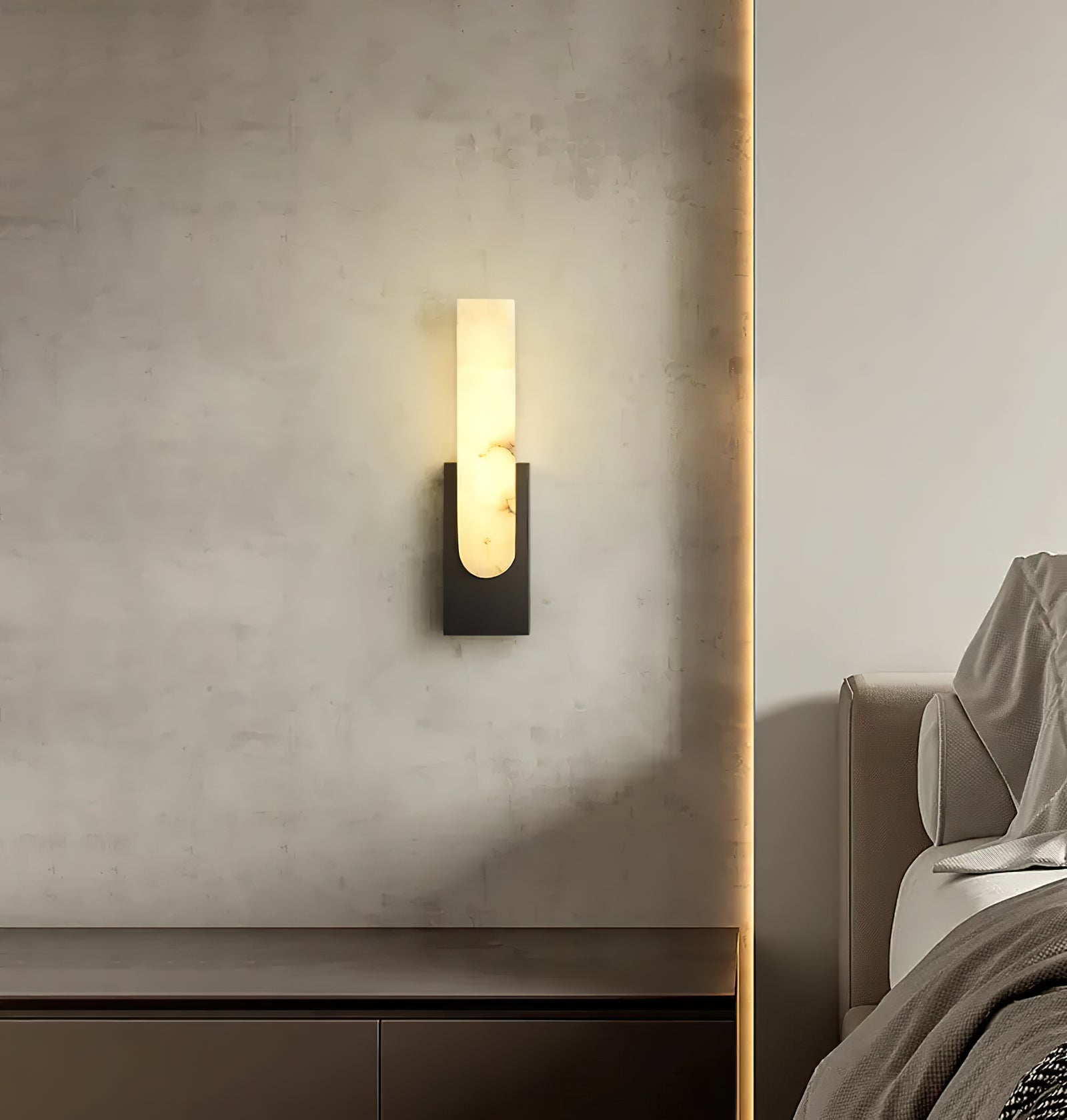 Black vertical sconce on textured wall