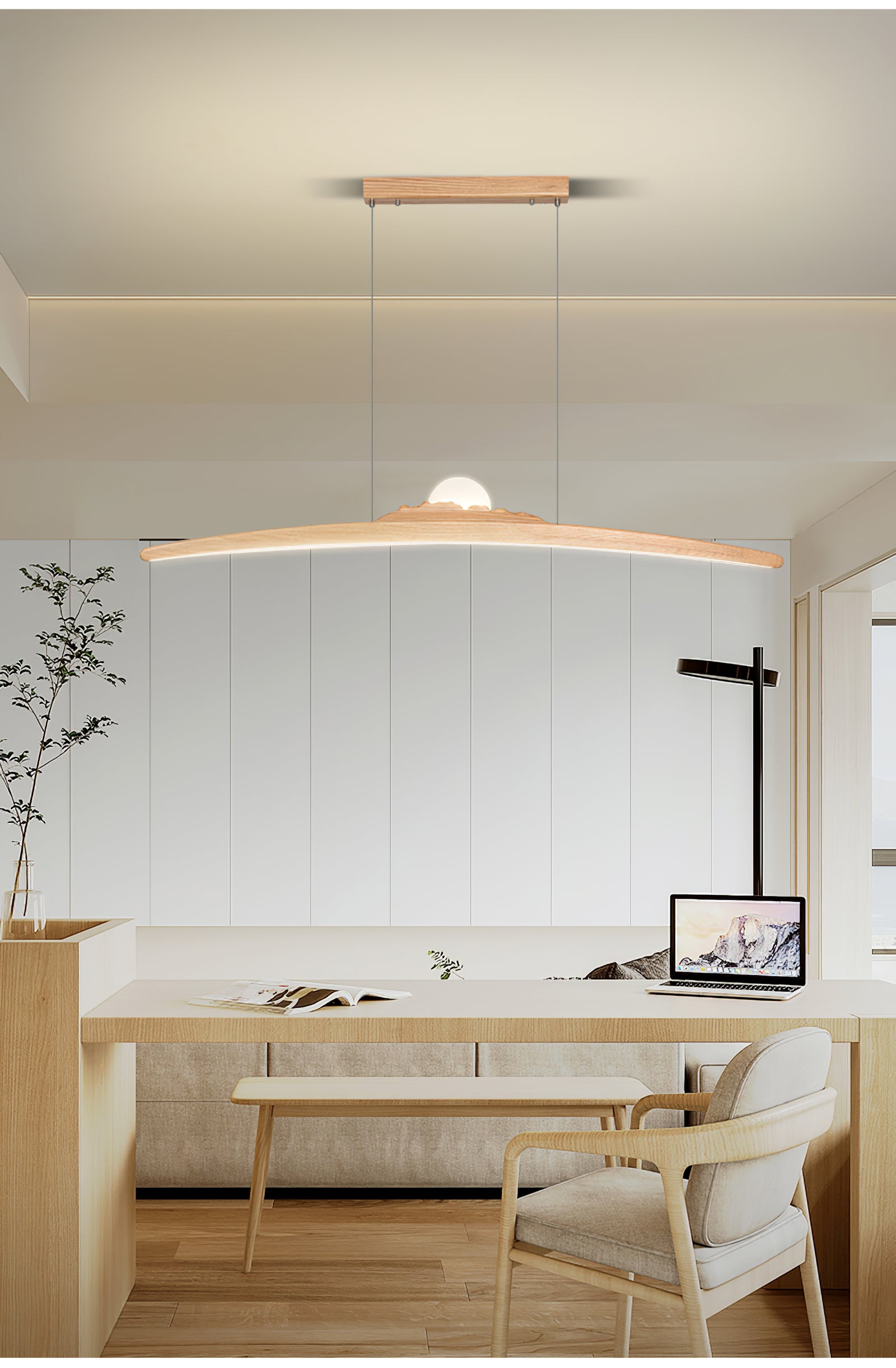 Pale wood pendant above a desk and laptop with a separate black floor lamp nearby