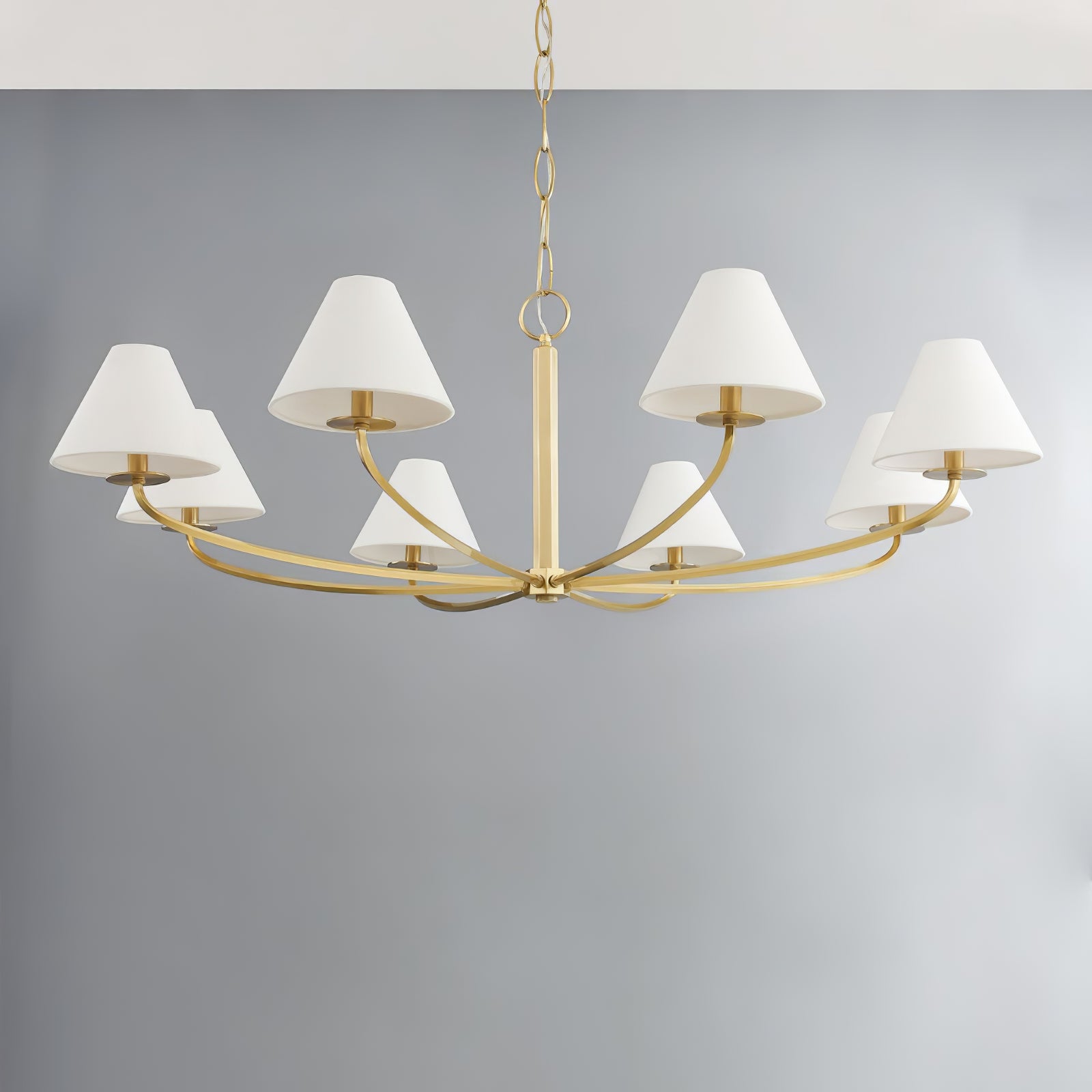 Eight-light Bronze Stacey chandelier with gold-tone radial arms and chain, white tapered shades against grey