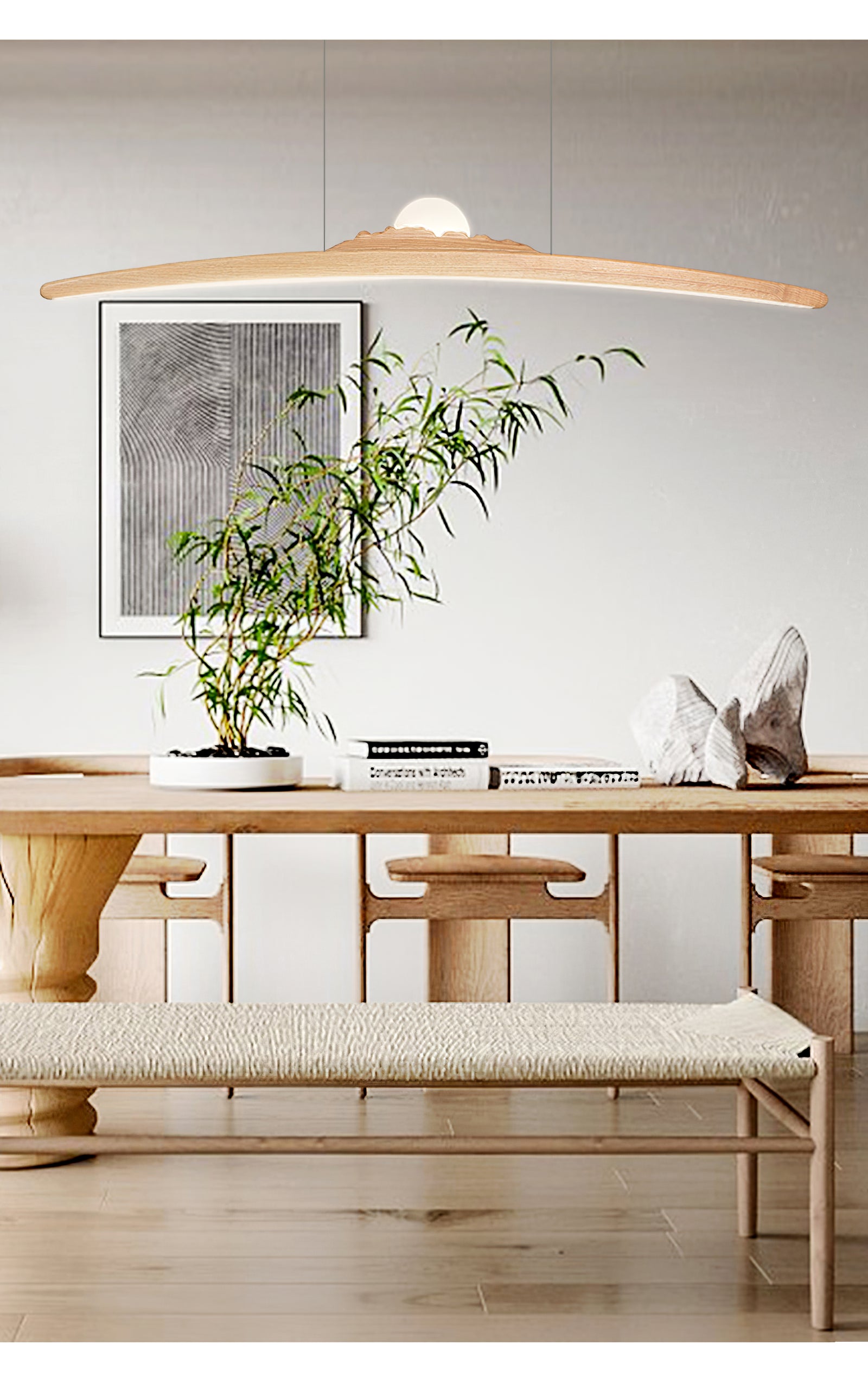 Pale curved wood pendant above a timber table, plant and cushioned bench beside framed artwork