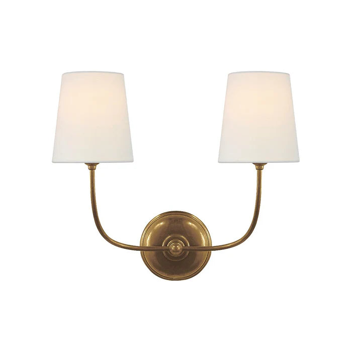 Vendome brass double wall light with upward curved arms and two white shades.