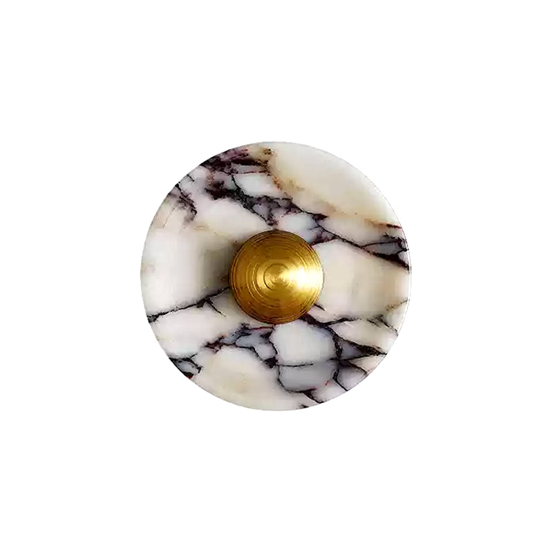 Front of the Gold finish: round pale veined stone disc with a ridged, projecting Gold centre