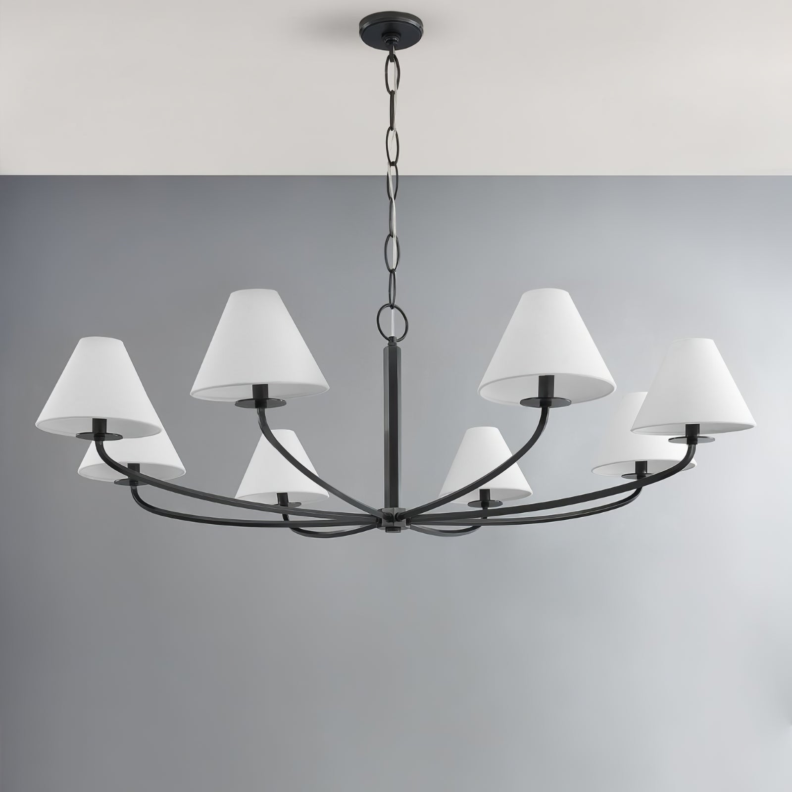 Eight-light Black Stacey chandelier with white tapered shades, curved arms, central stem, chain and canopy against grey