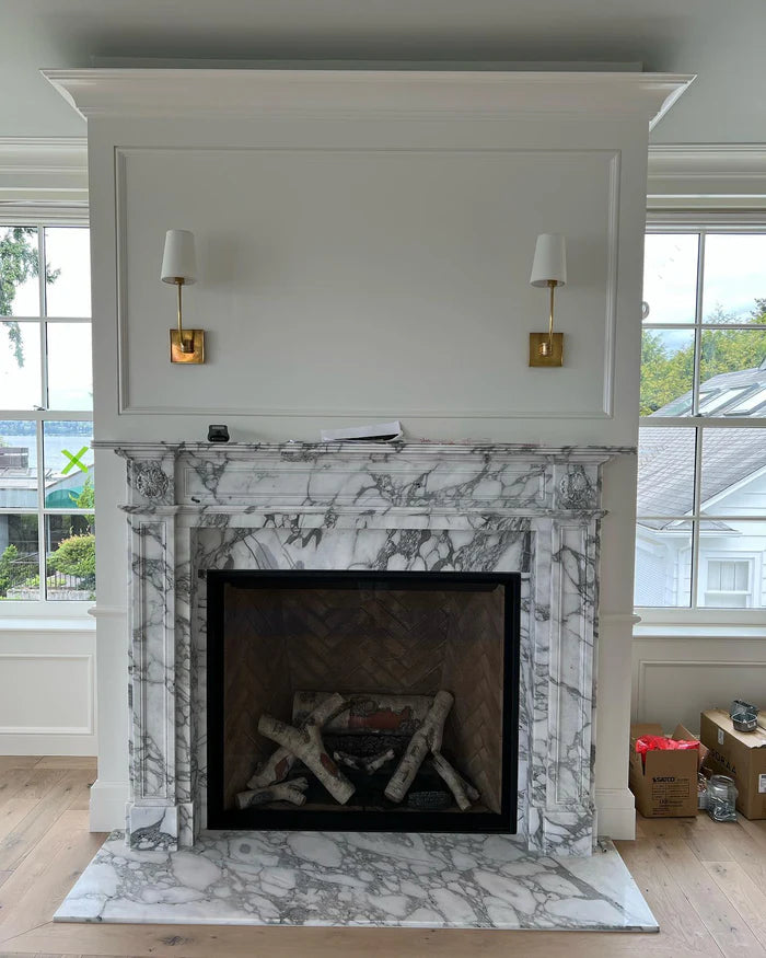 Two square-backplate single wall lights flanking a fireplace.