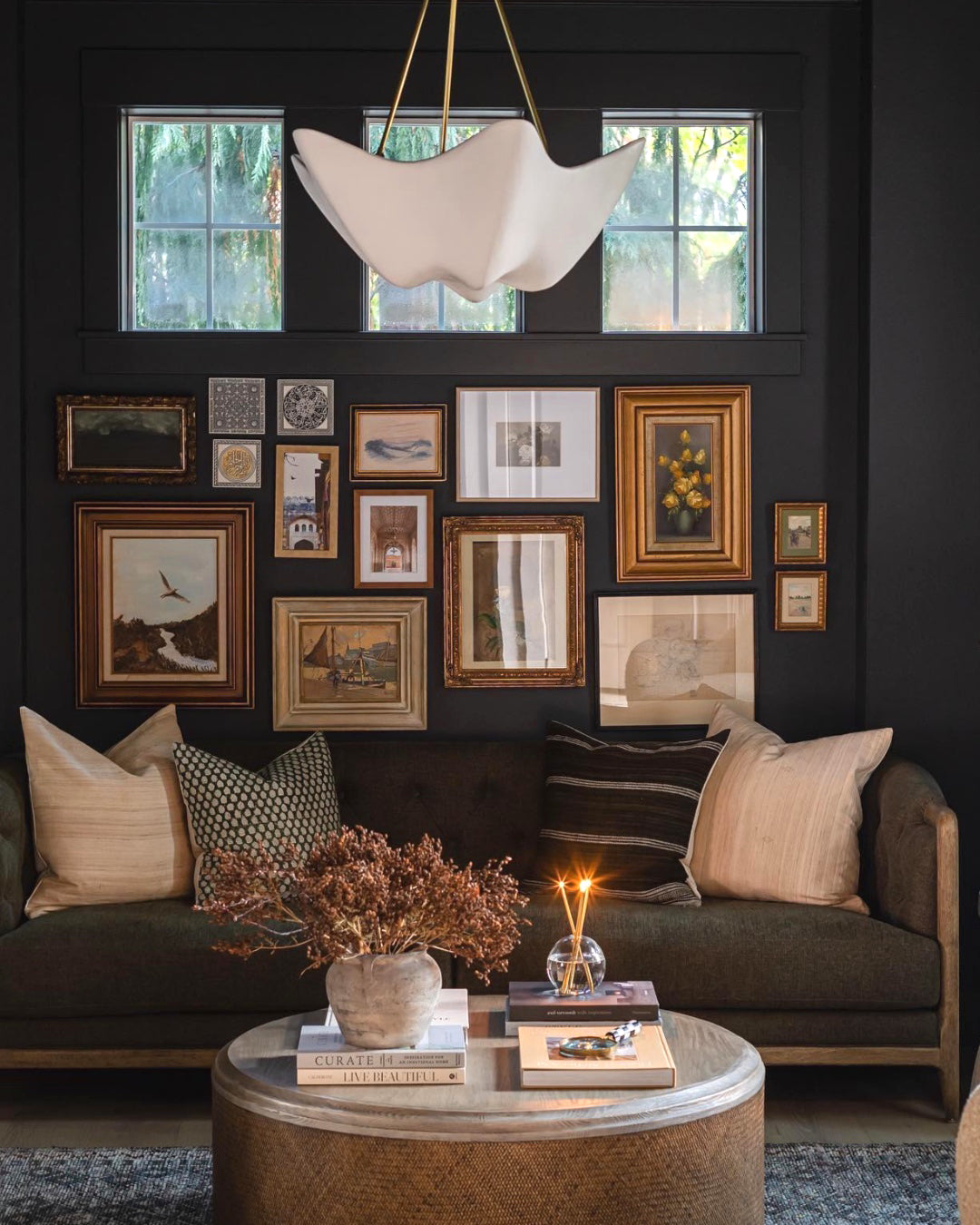 Cosima white bowl chandelier in a dark-walled living room