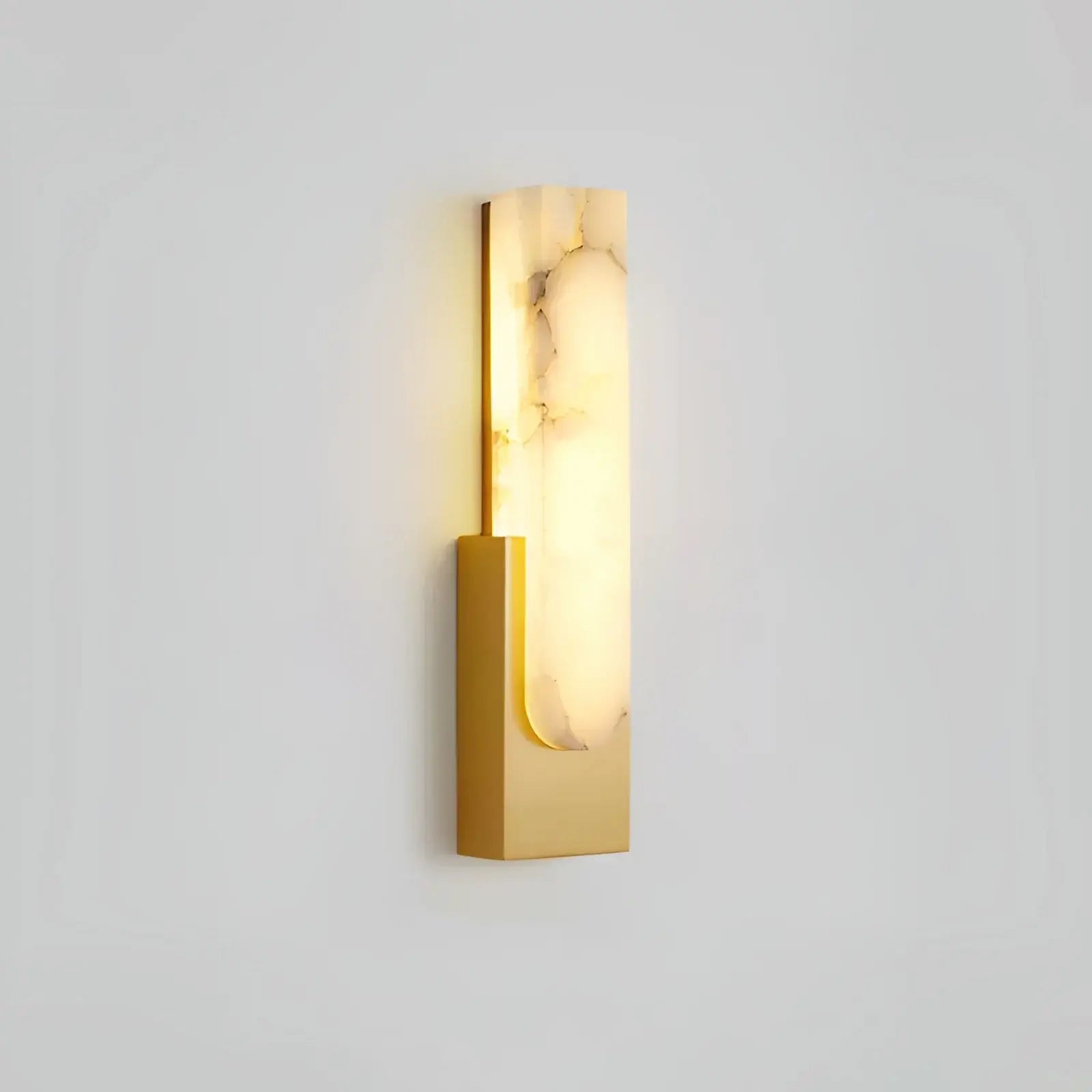 Gold single wall sconce on pale background