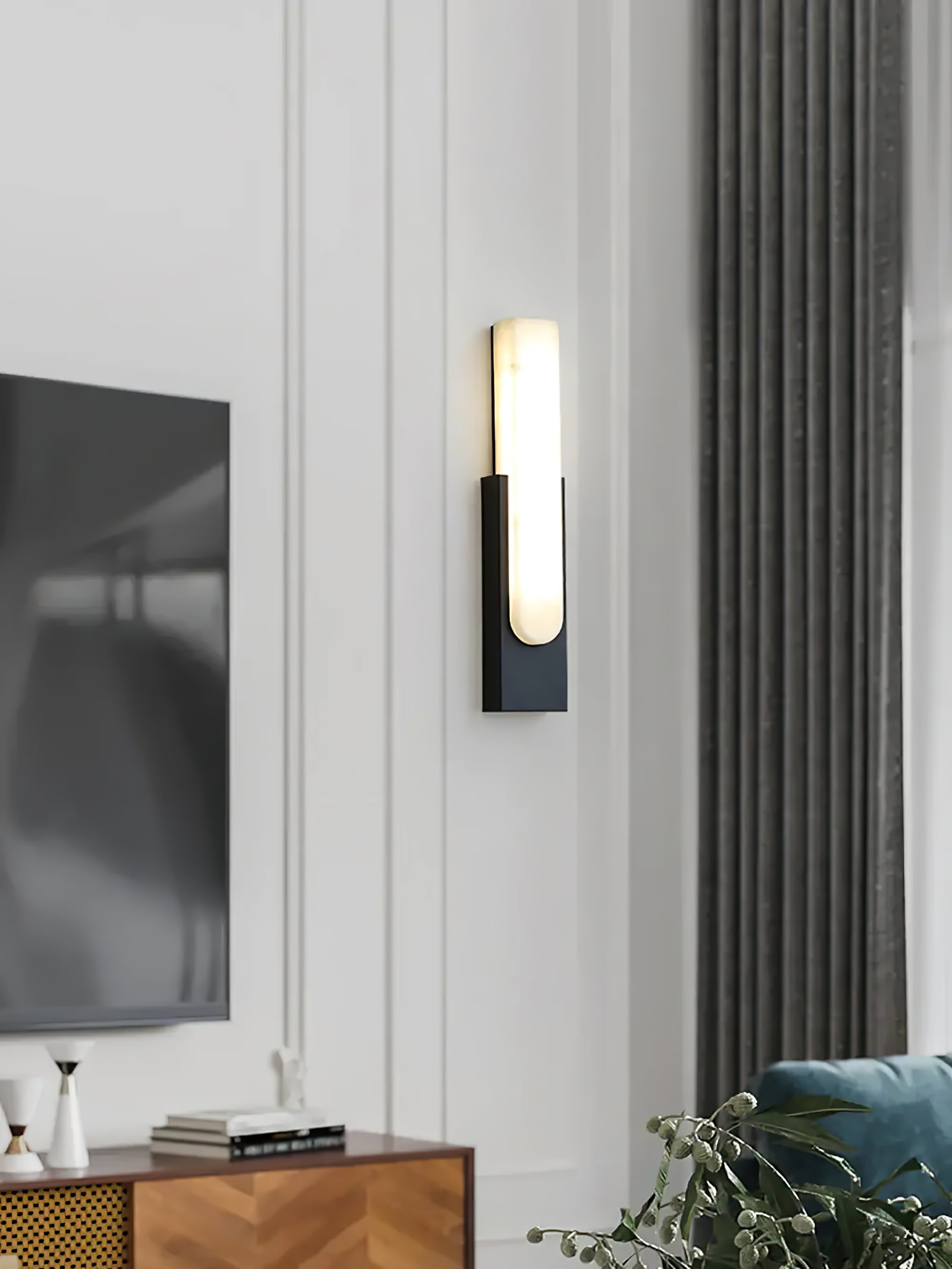 Black sconce near television cabinet