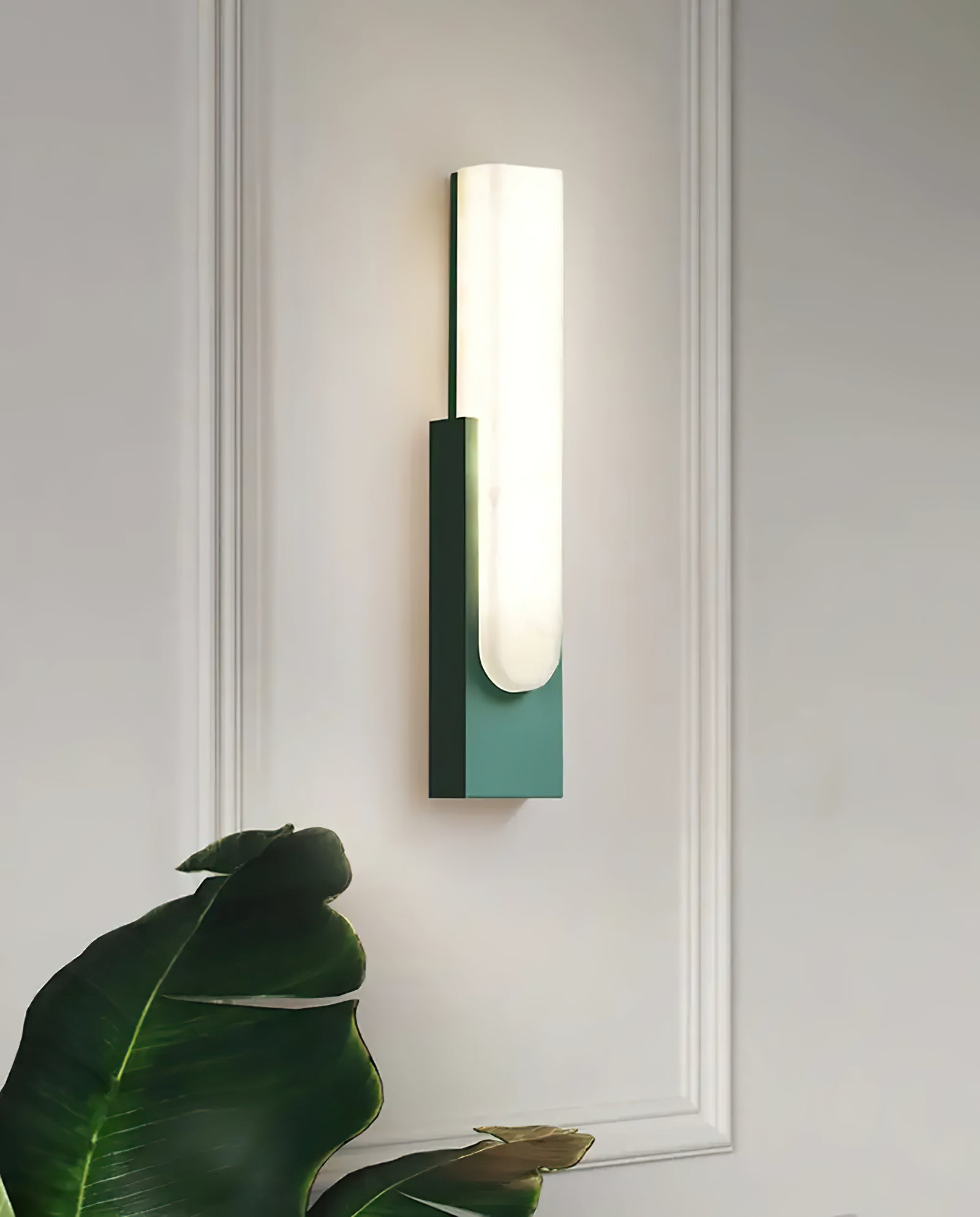 Green vertical sconce against paneled wall