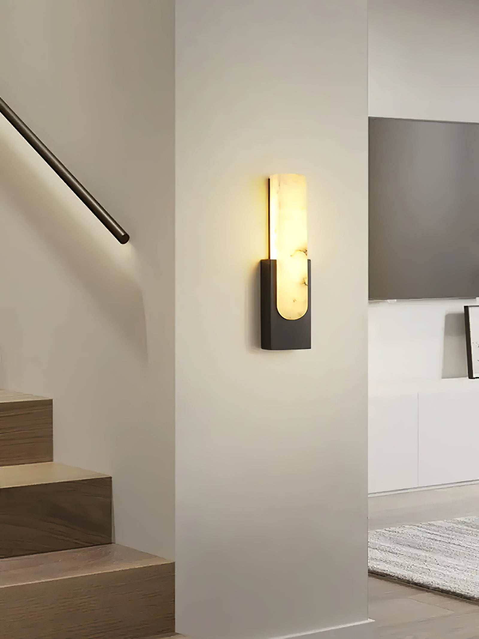Black sconce on hallway wall near stairs
