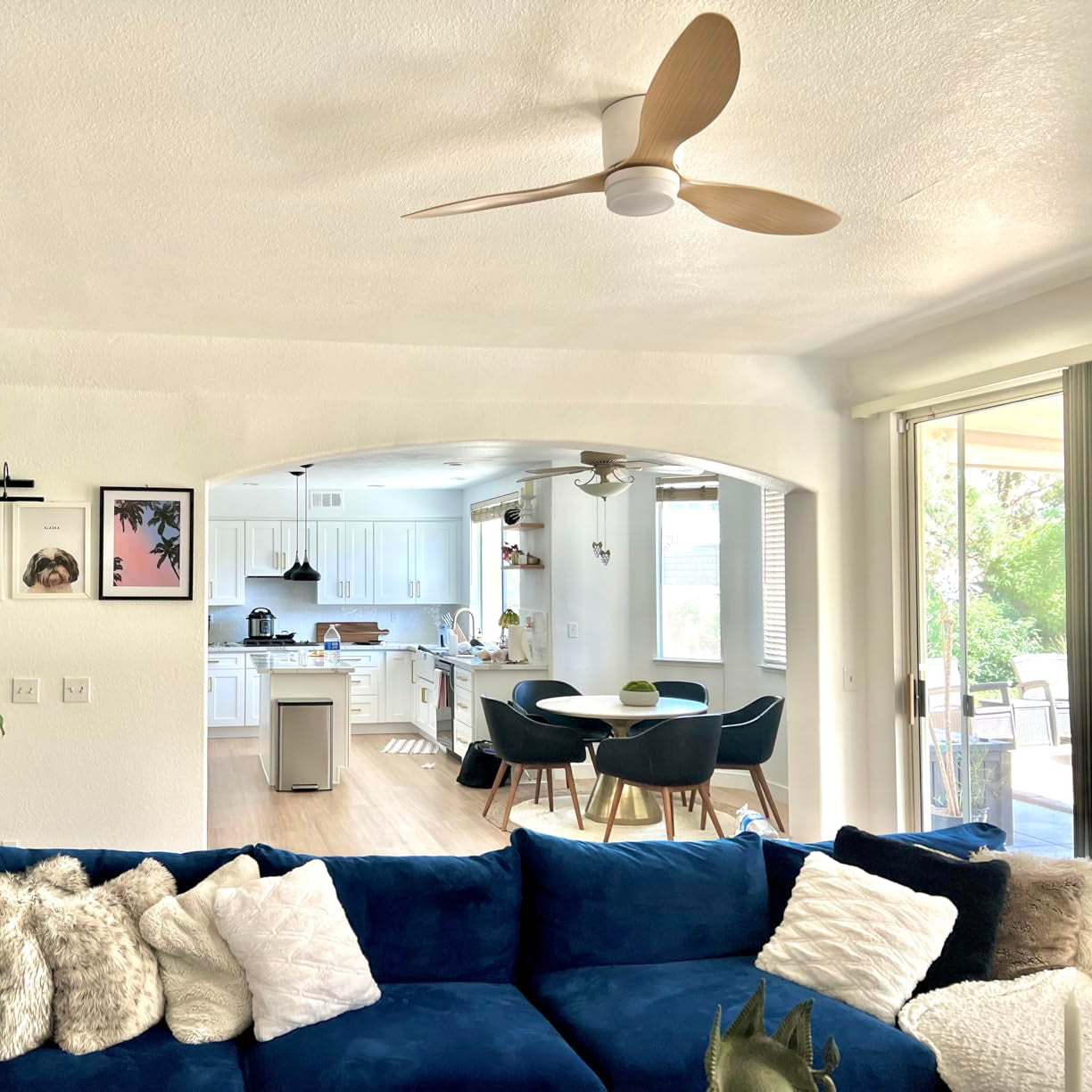 Wood-toned blades and White housing above a blue sofa