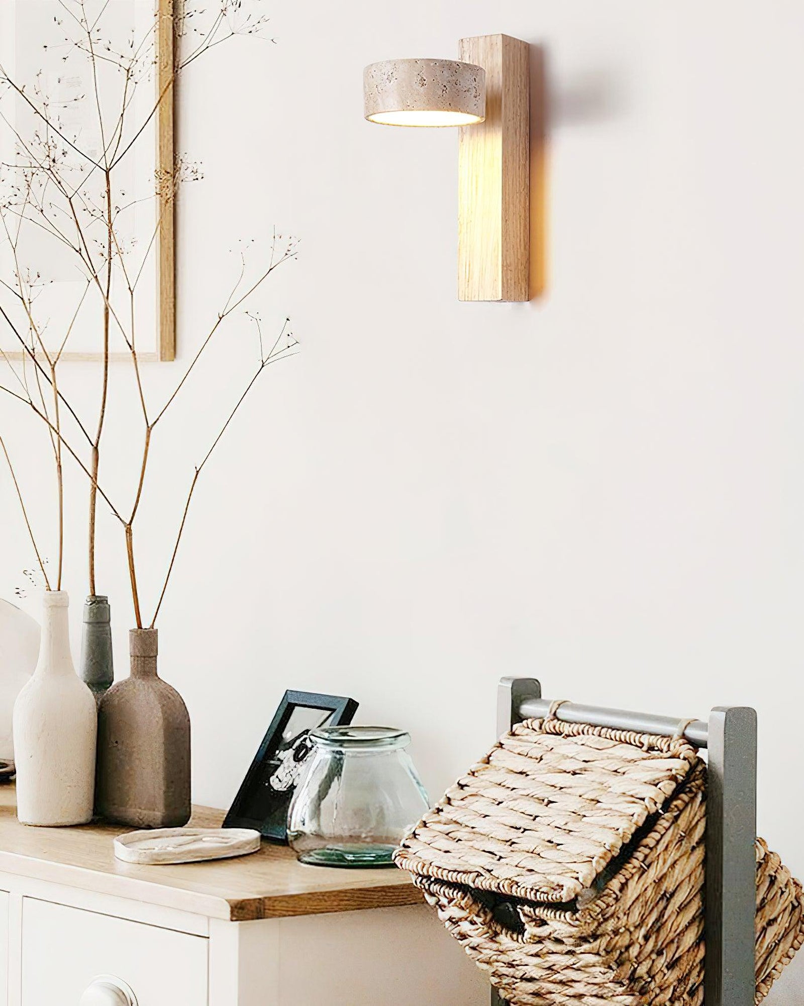 Light wood-colour travertine wall lamp above a cabinet