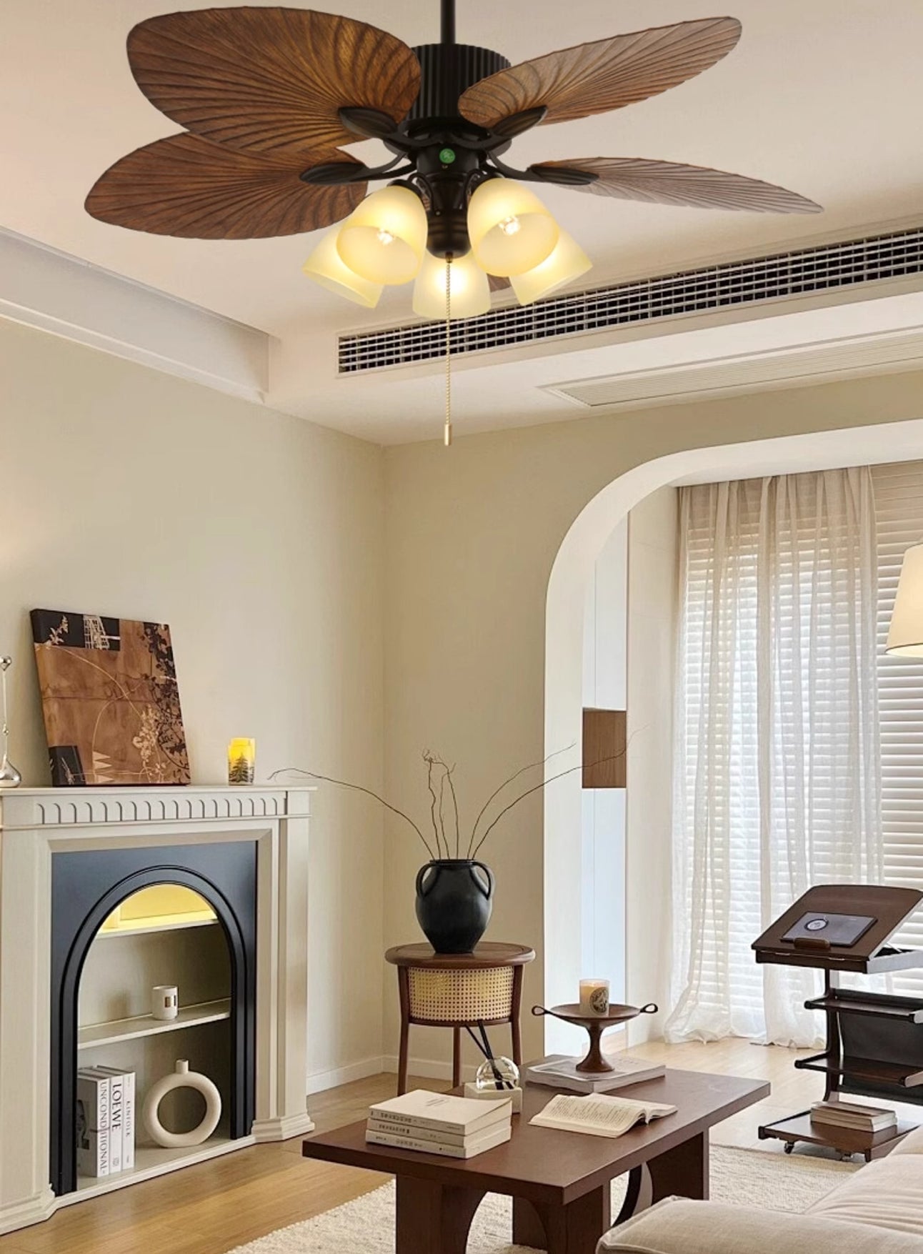 Broad leaf-pattern fan light in a living room with fireplace