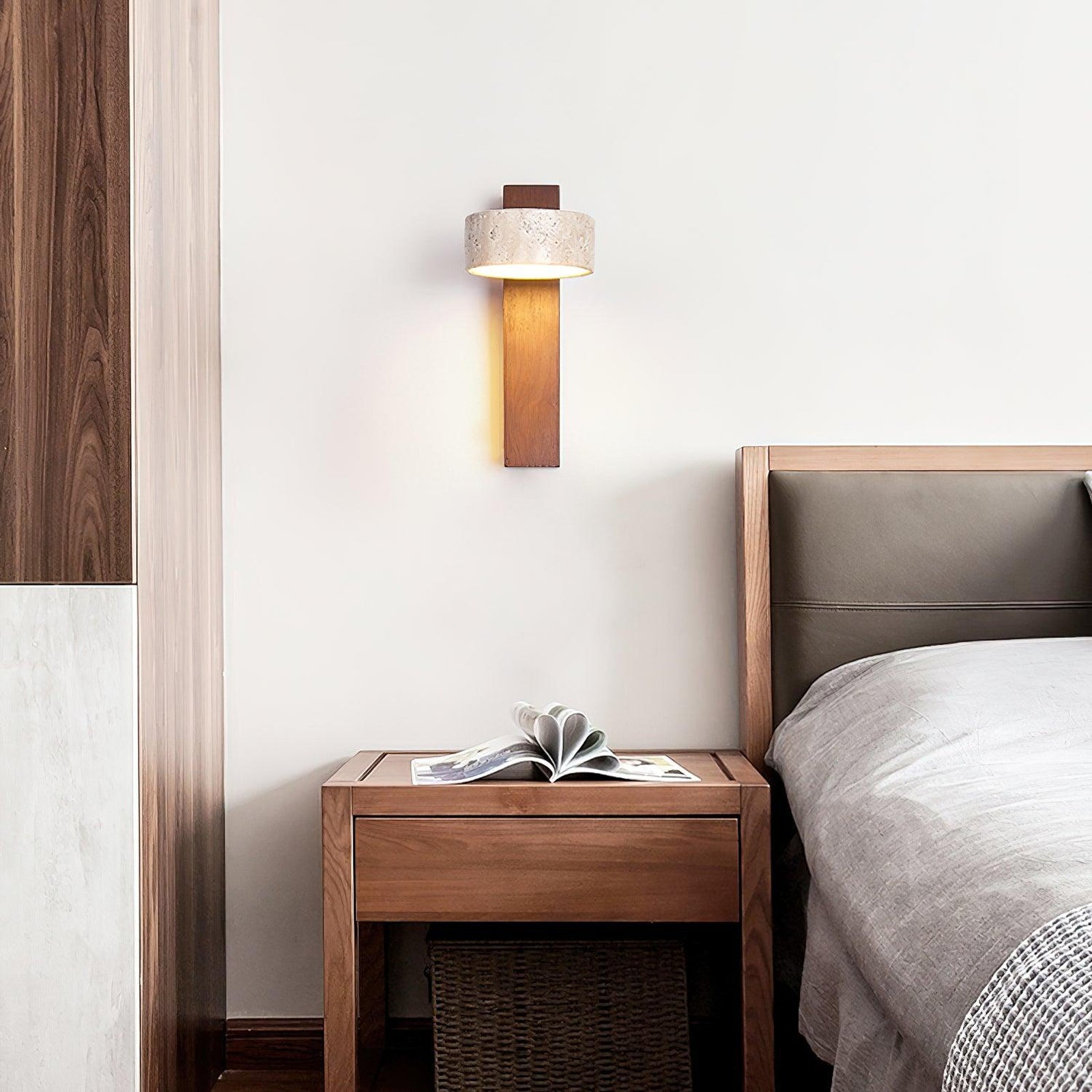 Walnut-colour travertine wall lamp beside a bed