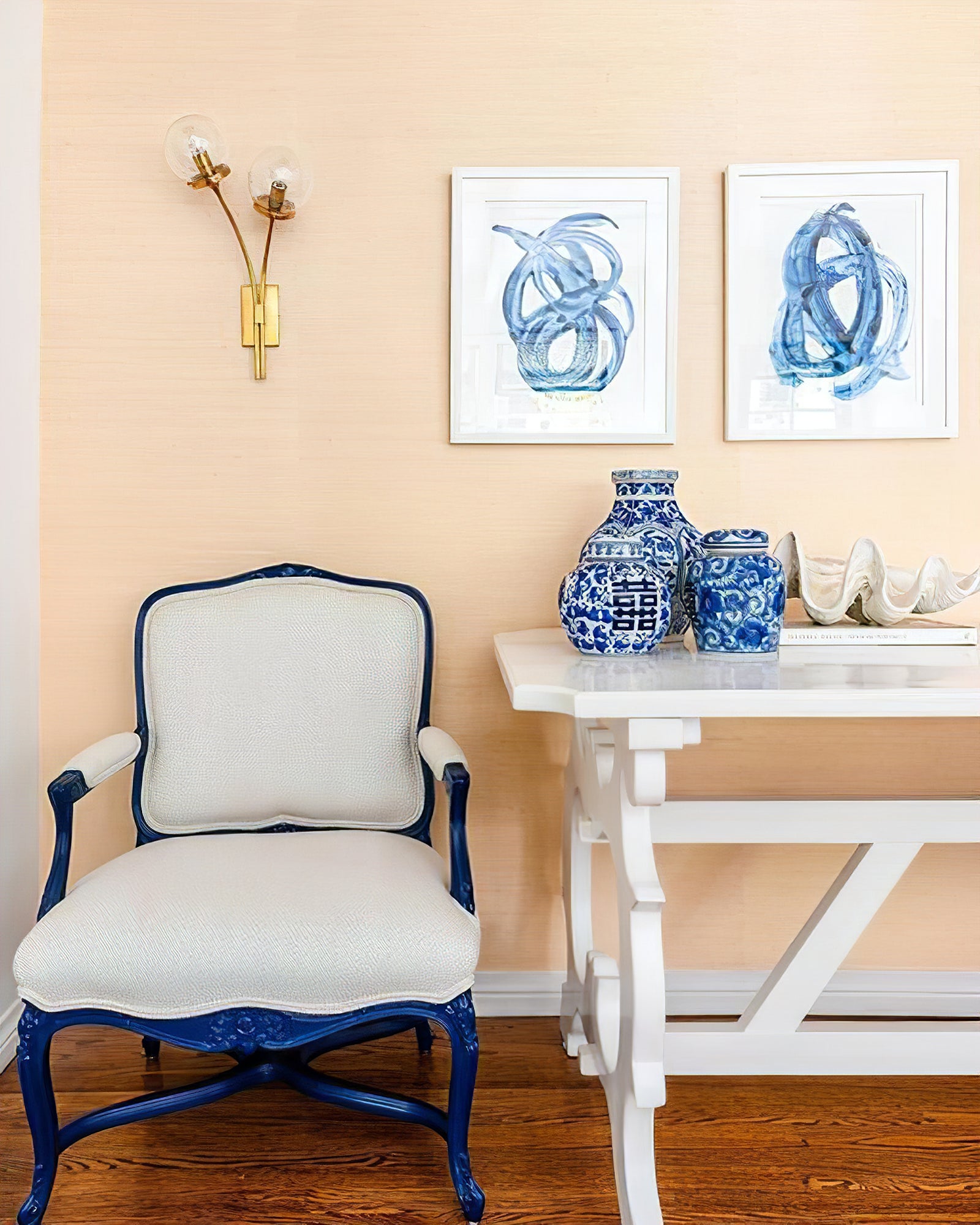 Brass clear-glass sconce above an armchair