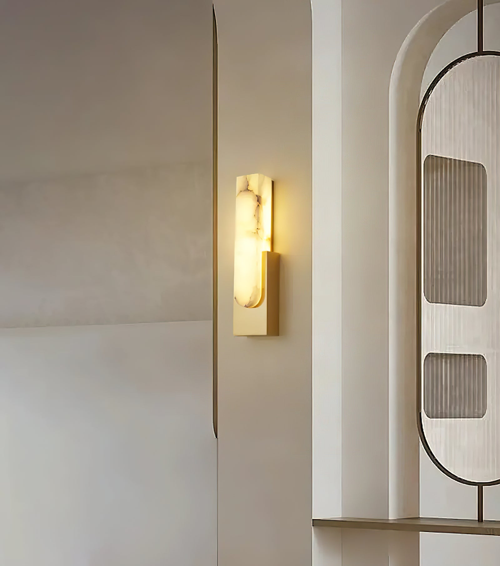 Gold sconce on pale hallway wall