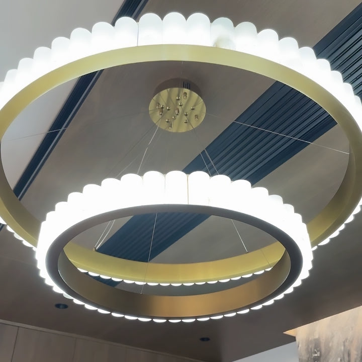 Two gold-tone-band rings with brightly lit pale segments viewed from below