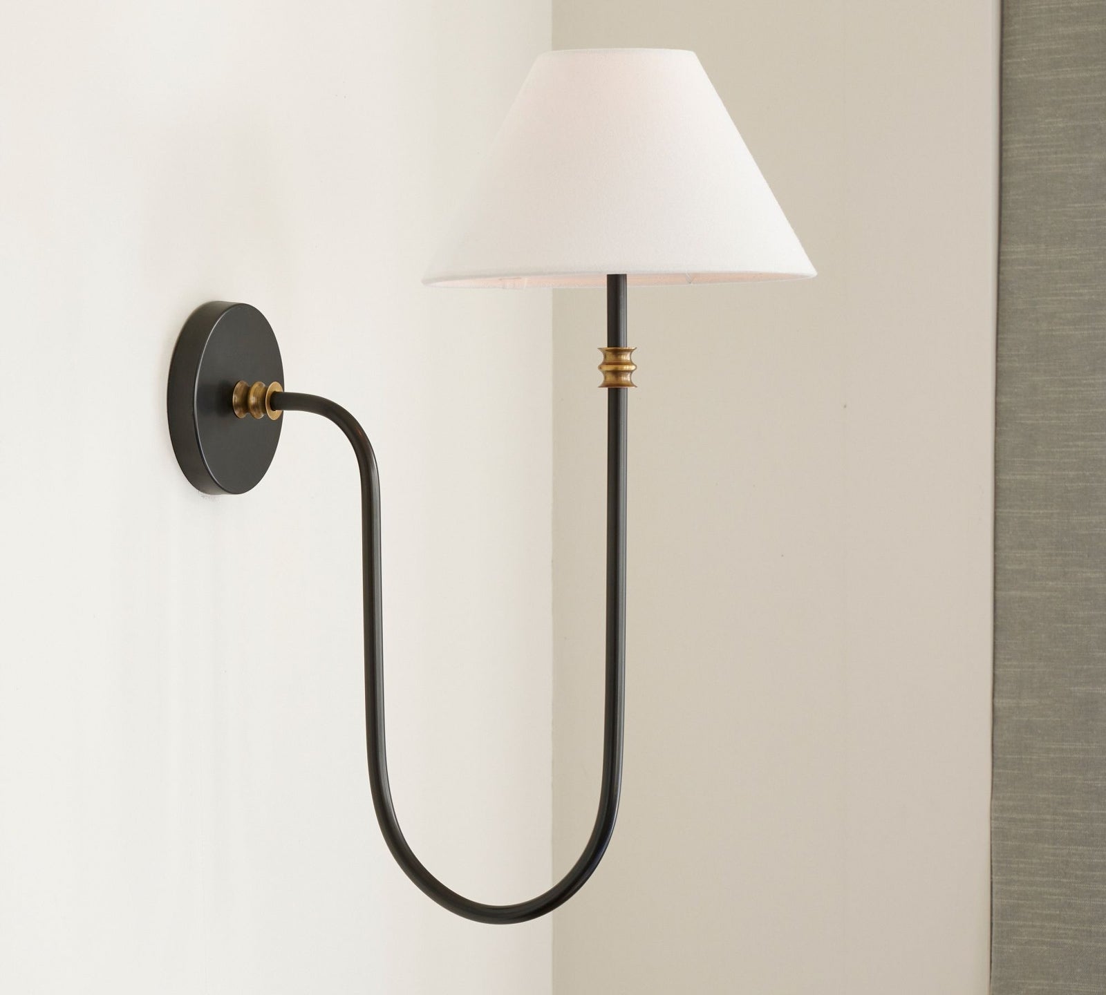 Side view of Collins lamp with white shade and U-shaped black arm