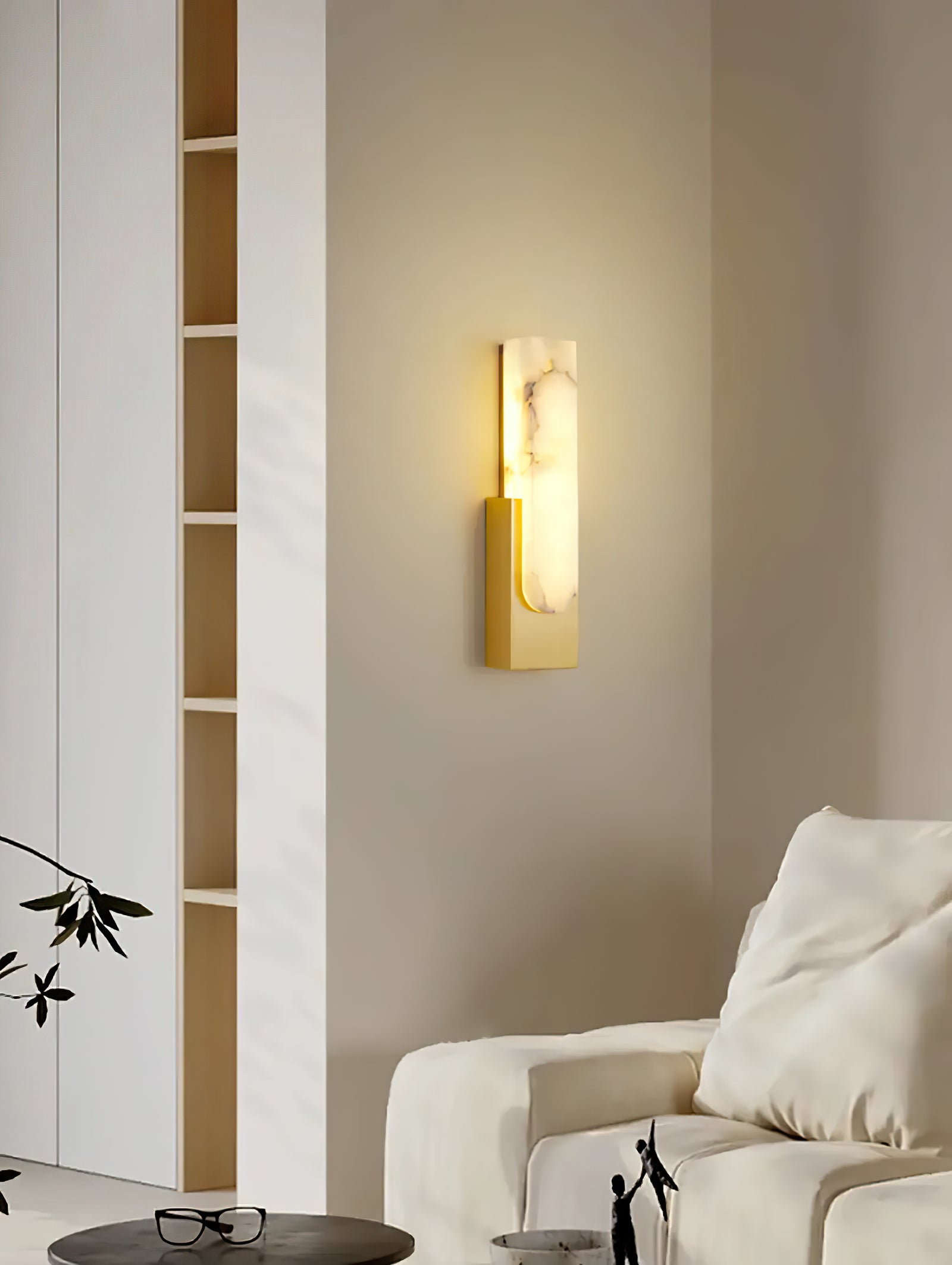 Gold wall sconce beside light sofa
