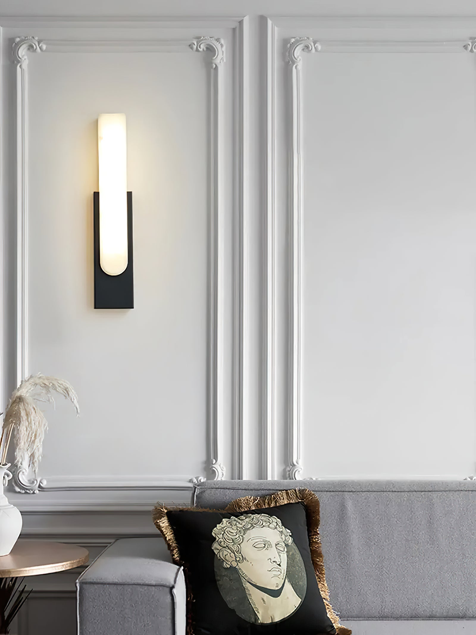 Black sconce above a living-room sofa