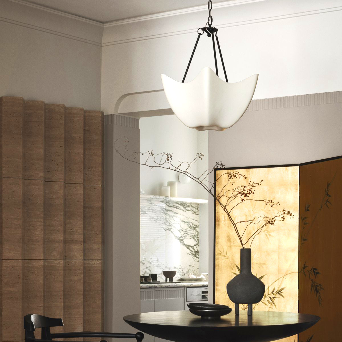Cosima white bowl chandelier with dark supports beside a table