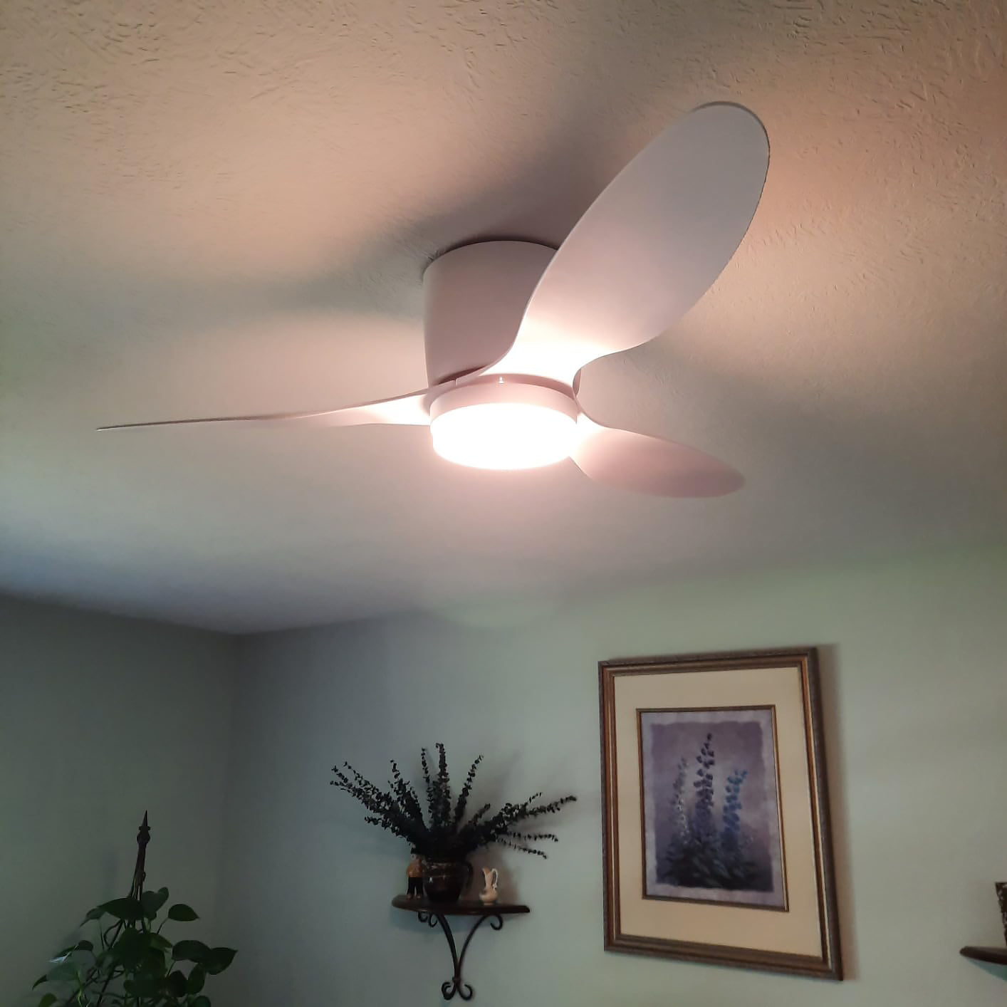 White fan with illuminated central panel in a room
