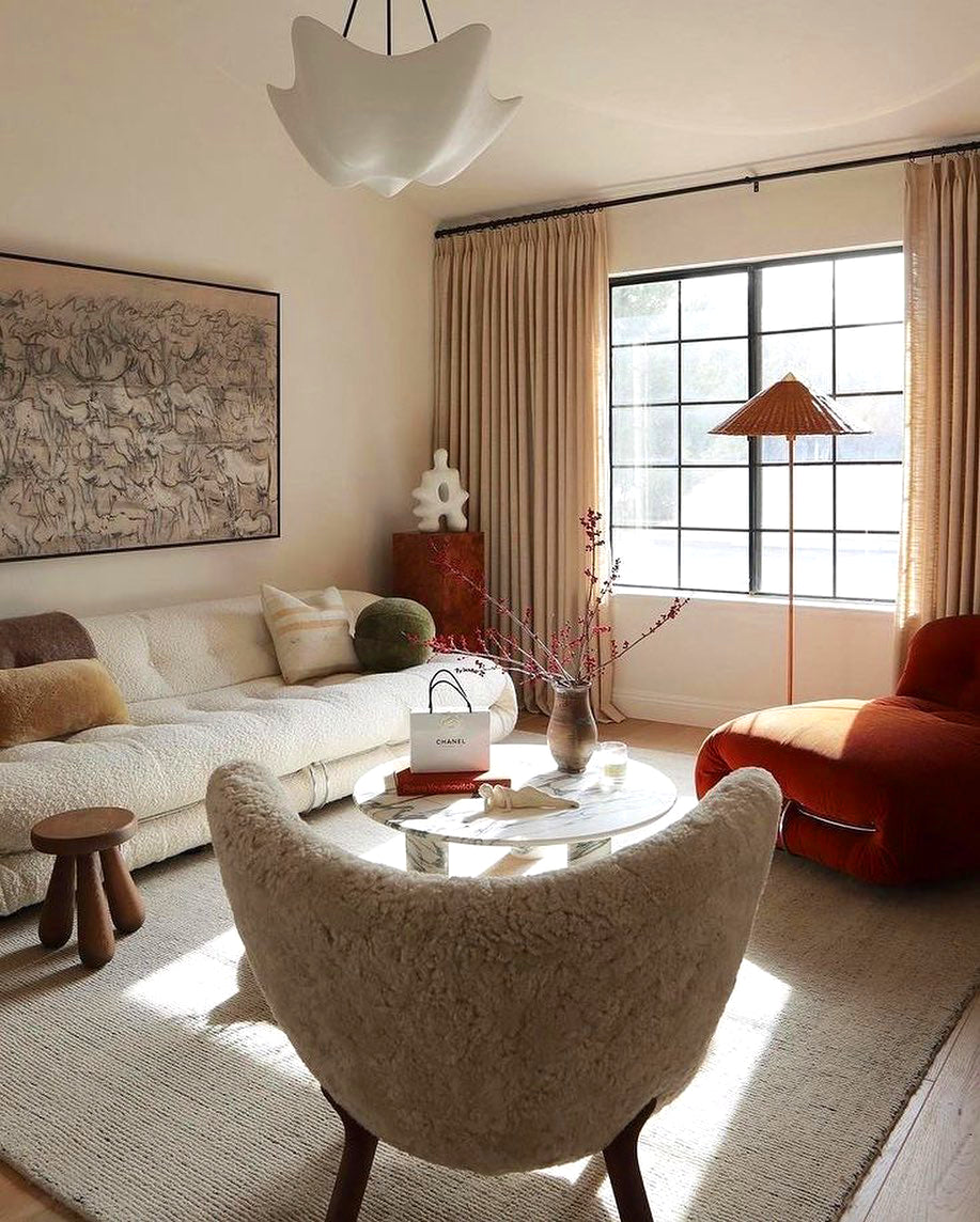 Cosima chandelier in a living room with a red chair