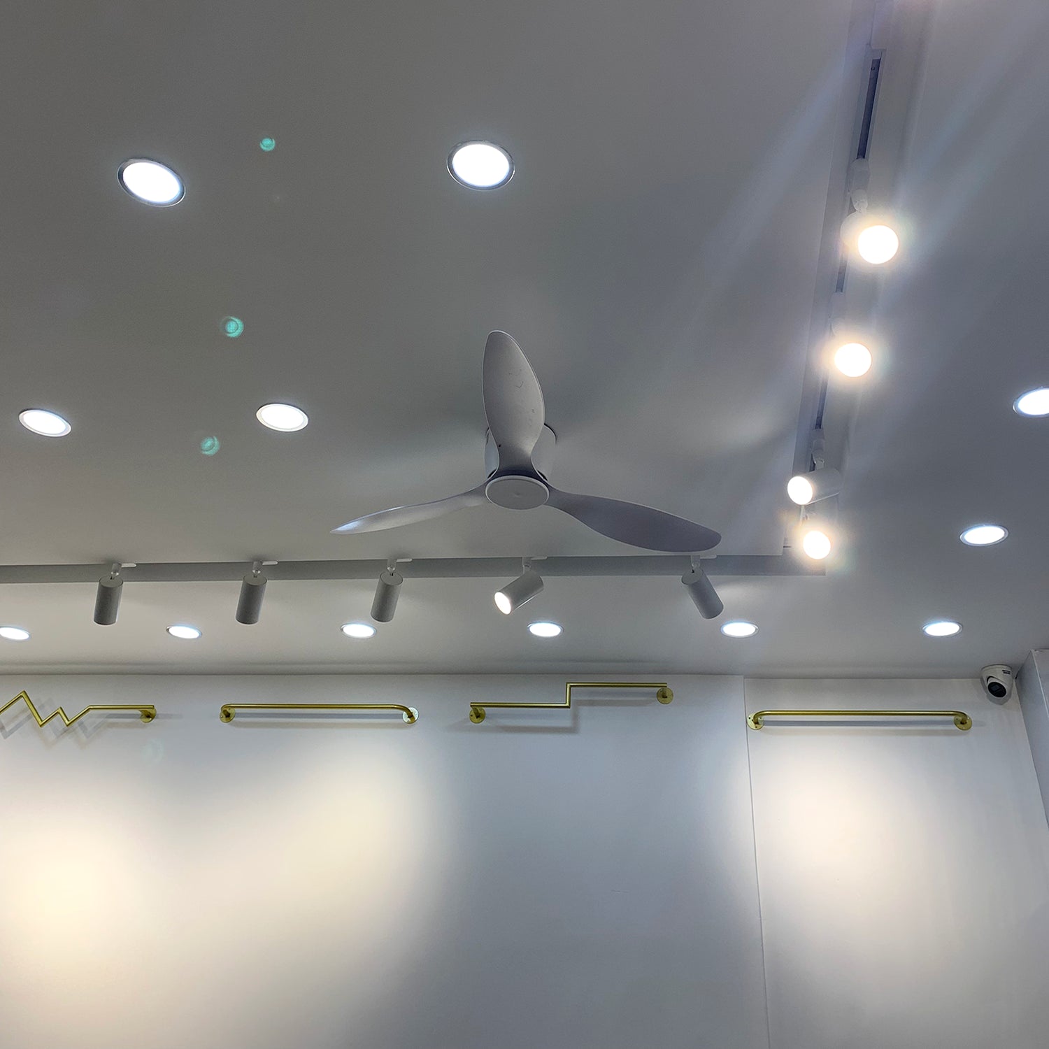 Ceiling fans displayed beneath a showroom ceiling