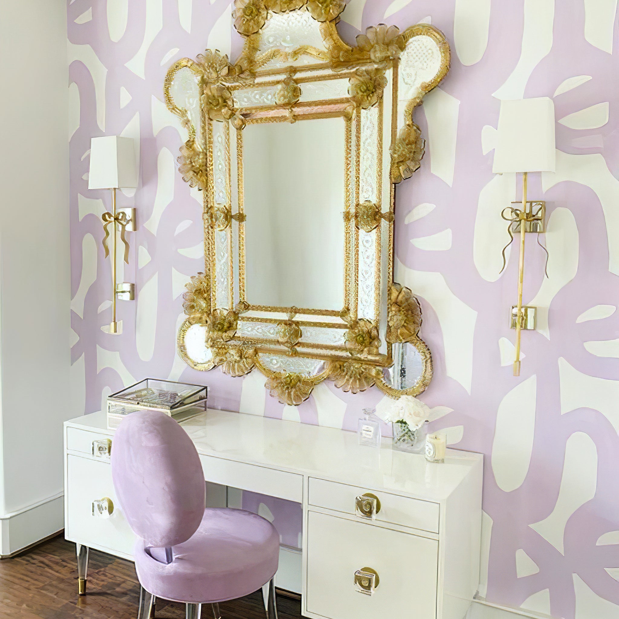 Two white Ellery sconces flanking a gold mirror above a dressing table