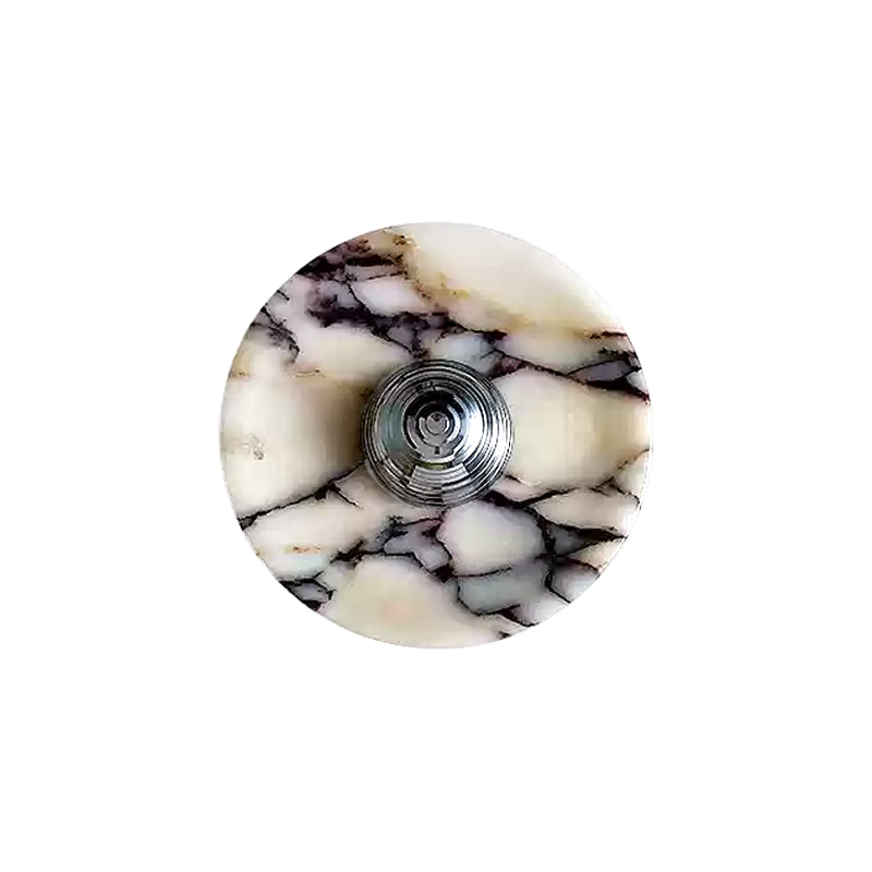 Front of the Silver finish: round pale veined stone disc with a ridged, projecting Silver centre