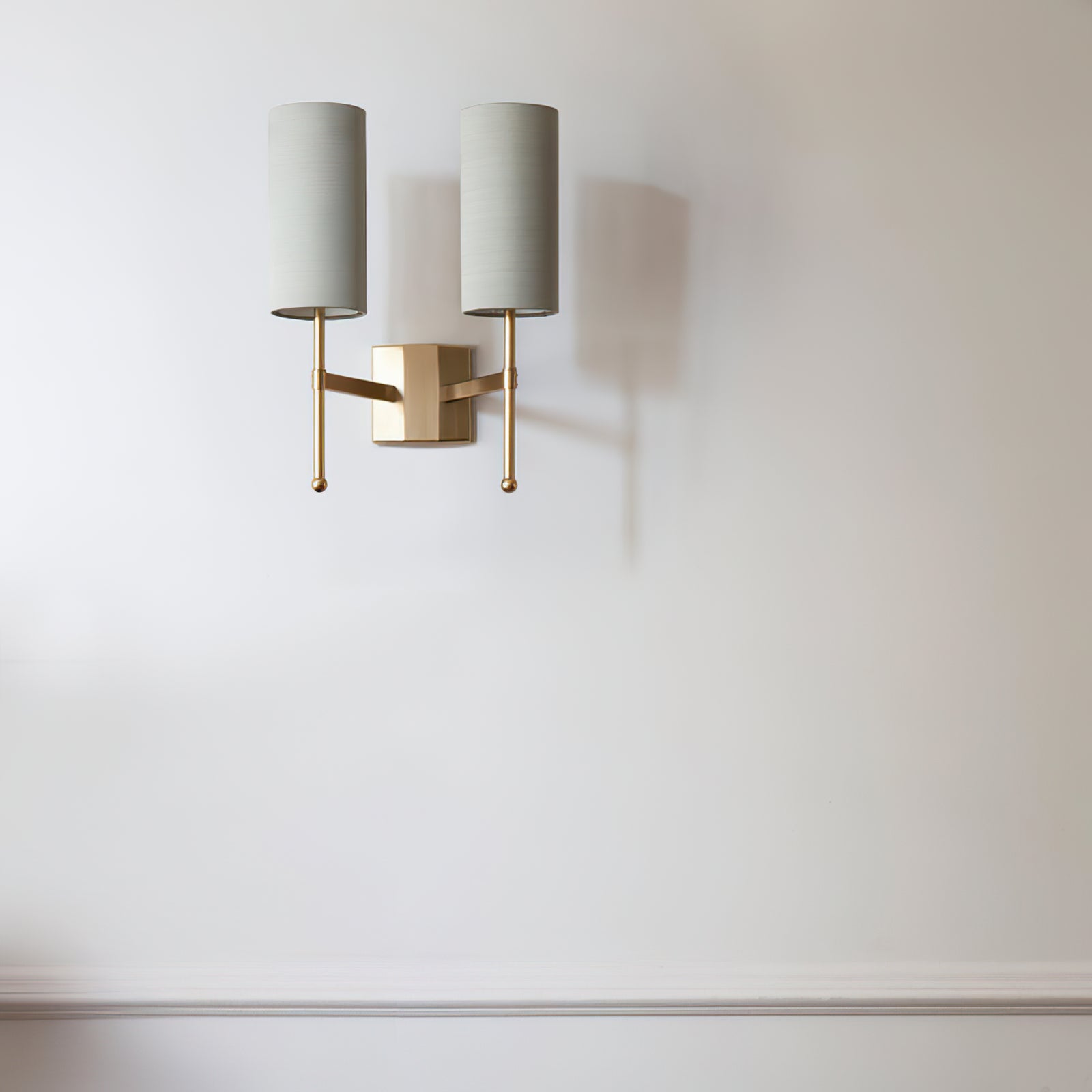 Silk Double Rod two pale grey cylinder shades on a white wall