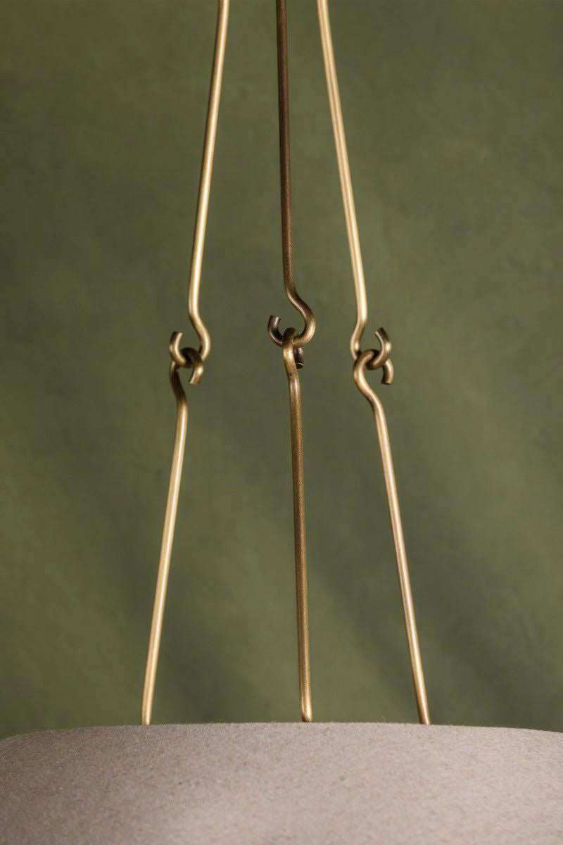 Slender hooked metal supports above the Troy Archive shade