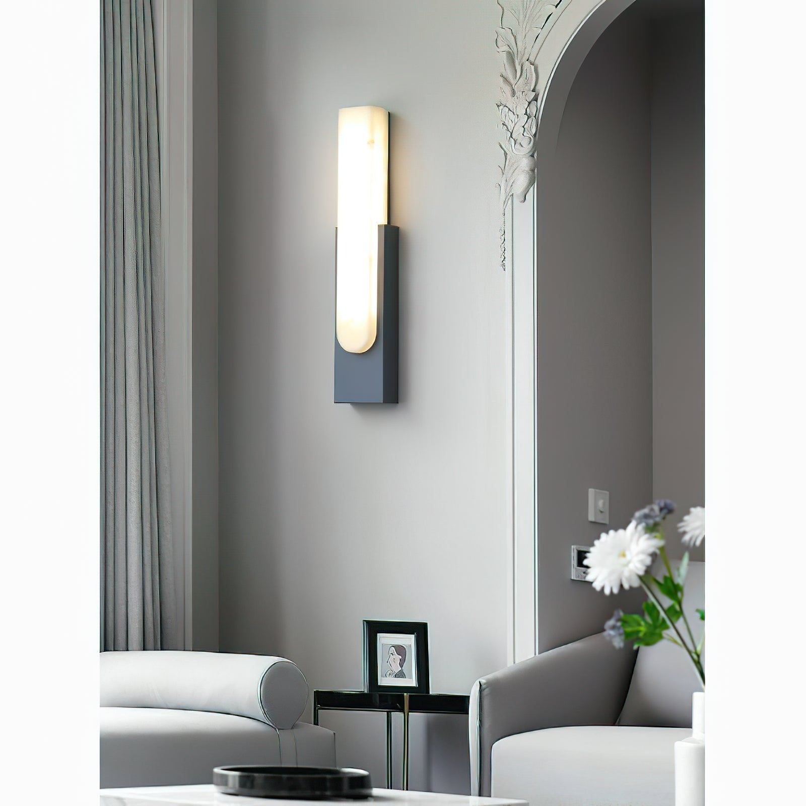 Gray sconce beside curtains and pale chair