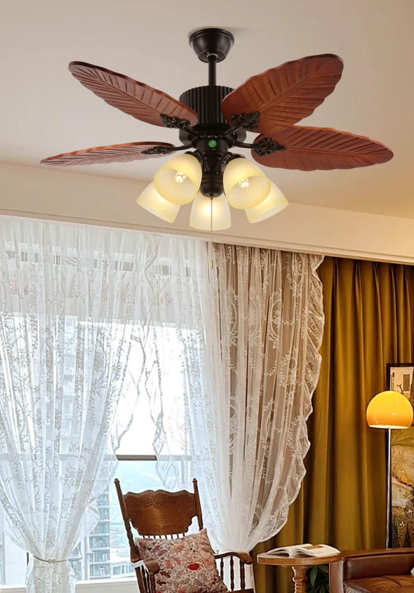 Pointed leaf-pattern fan light above a curtained window