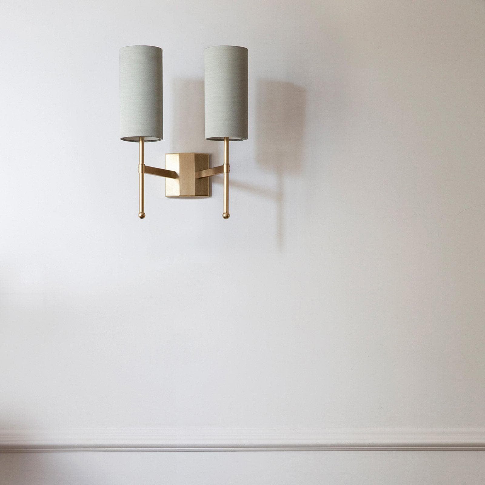Silk Double Rod twin grey shades on a light wall