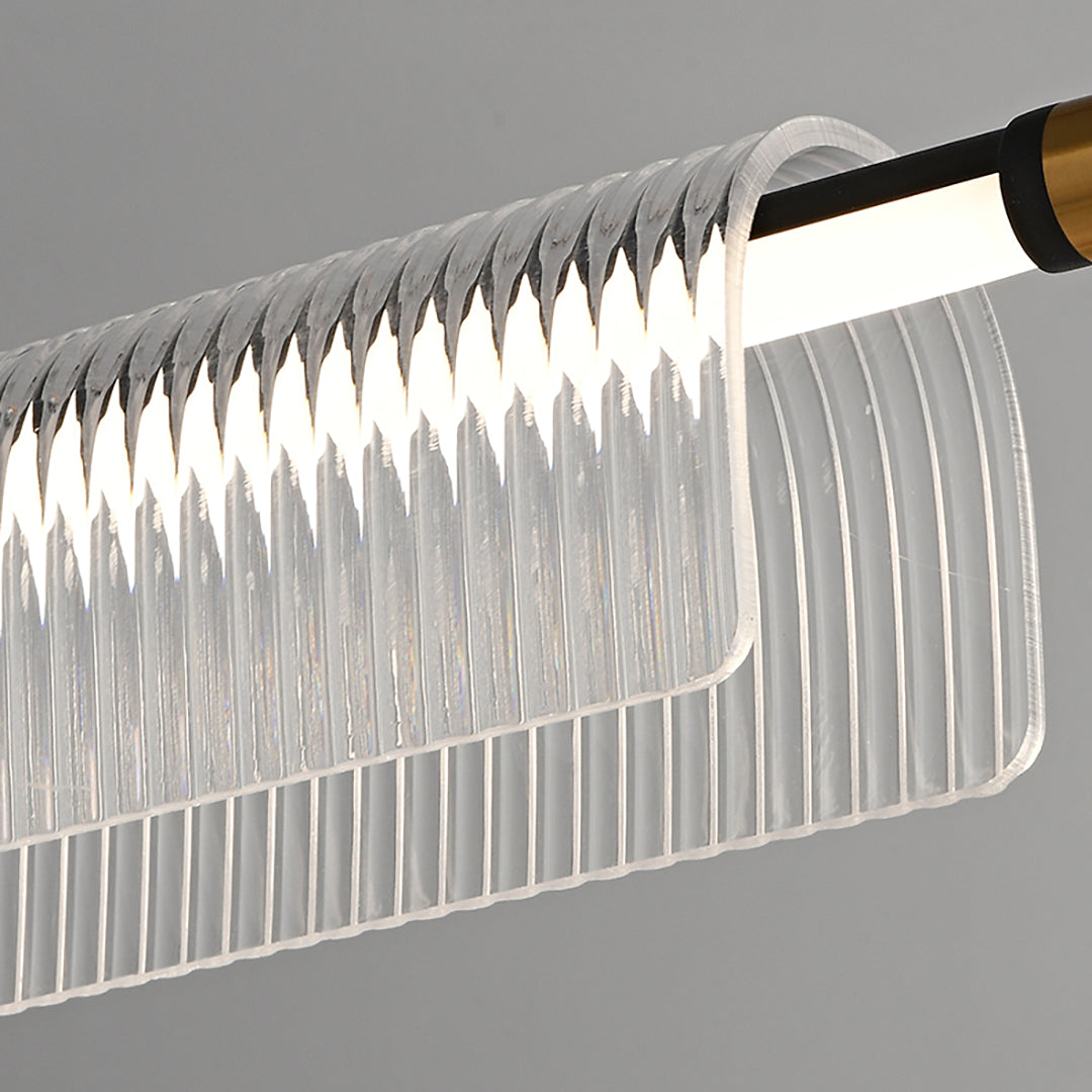 Close-up of a black bar, illuminated strip and curved ribbed acrylic profile with a gold-tone end detail