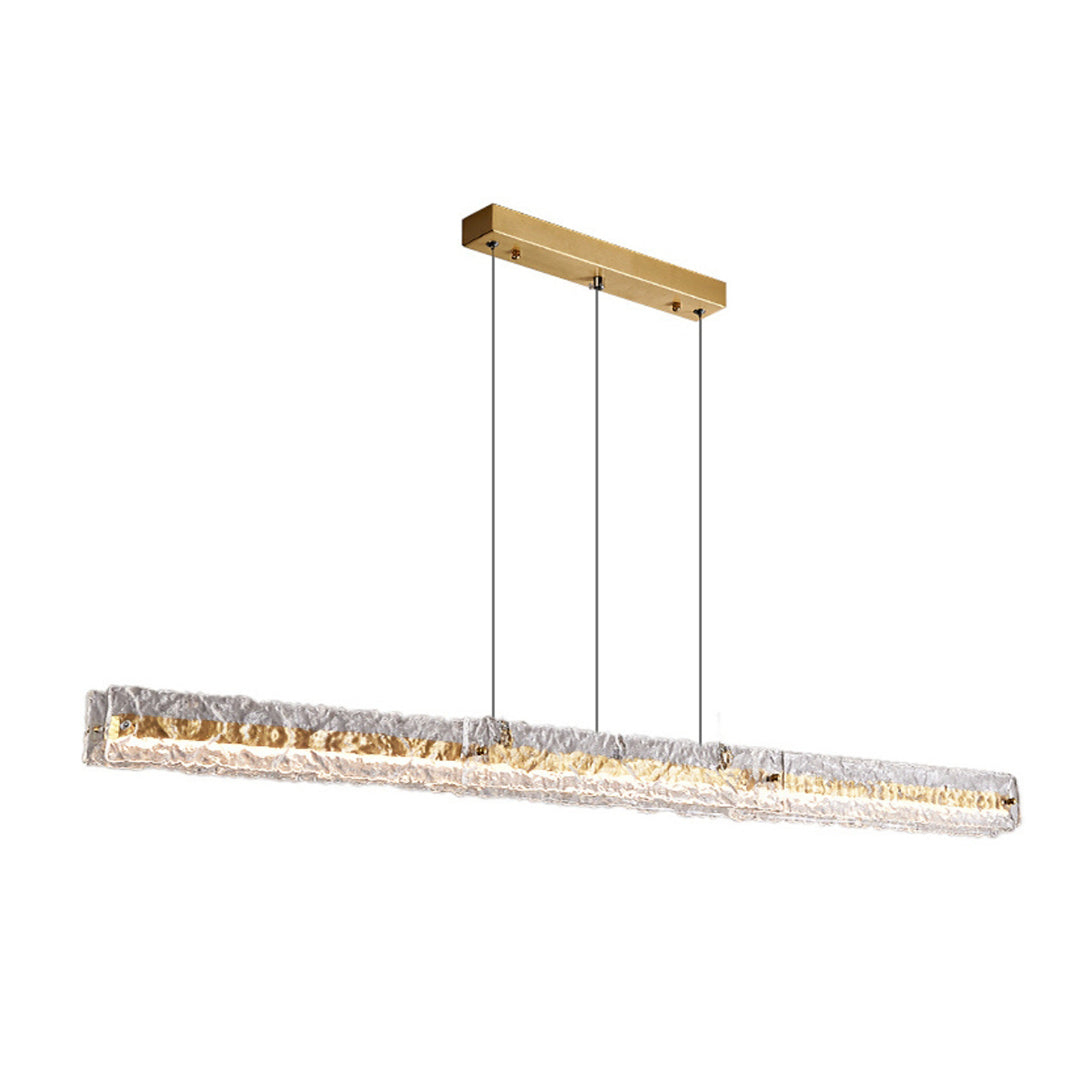 Long gold-toned textured clear-glass pendant beneath a rectangular canopy, frontal view on white