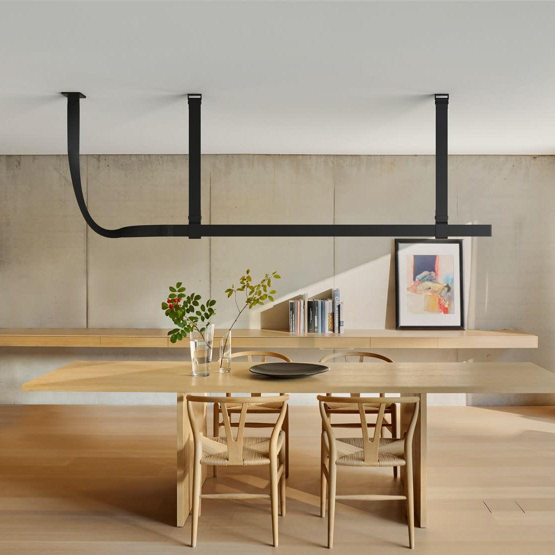 Black horizontal Belt pendant above a dining table
